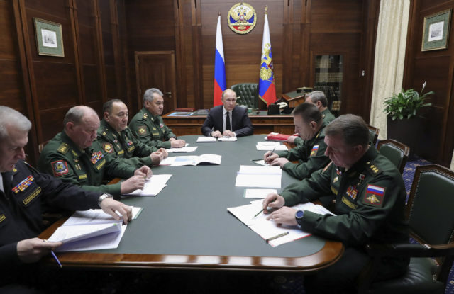 Vladimir Putin speaks to his military chiefs