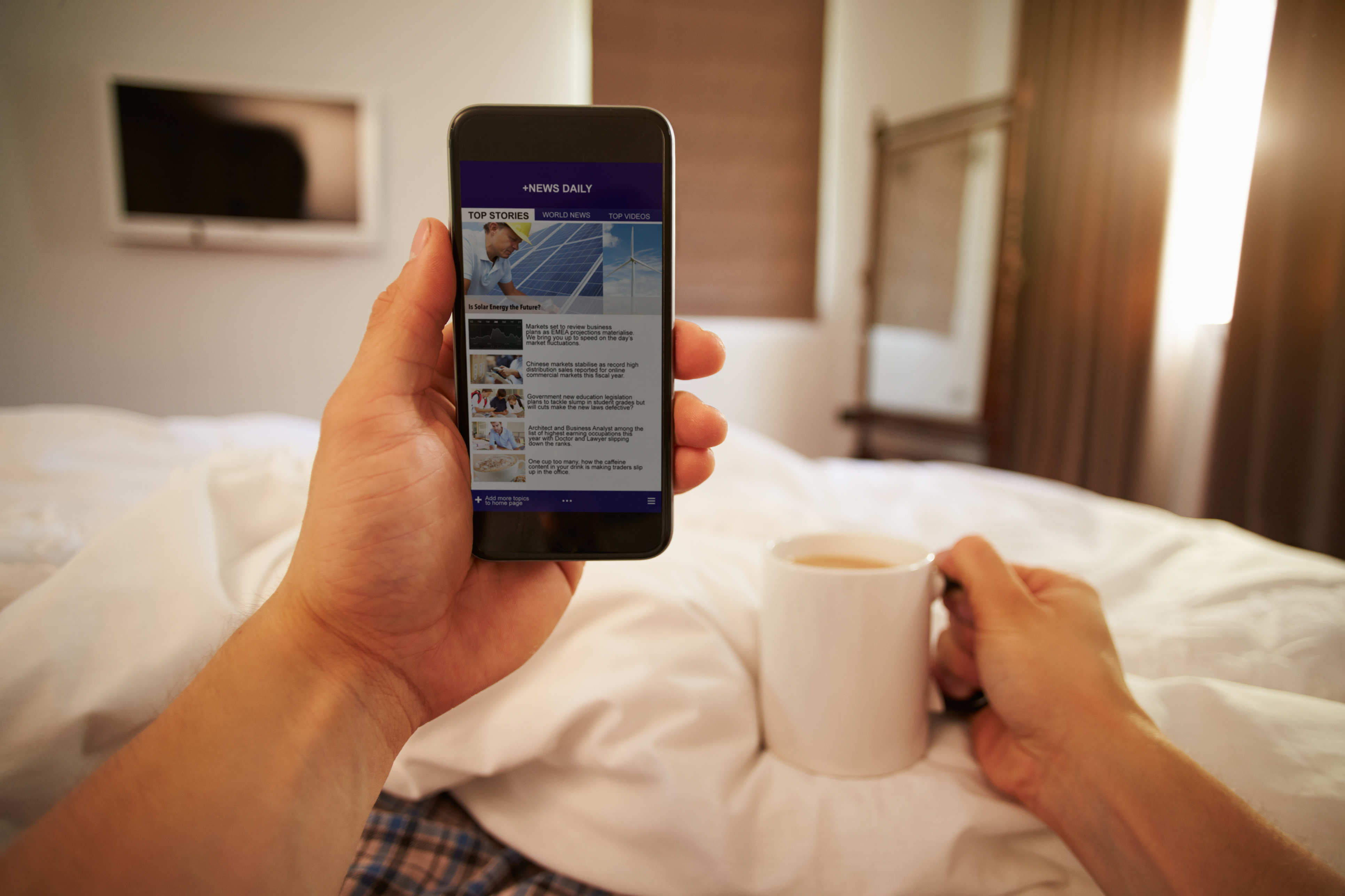 A man checks his email in bed