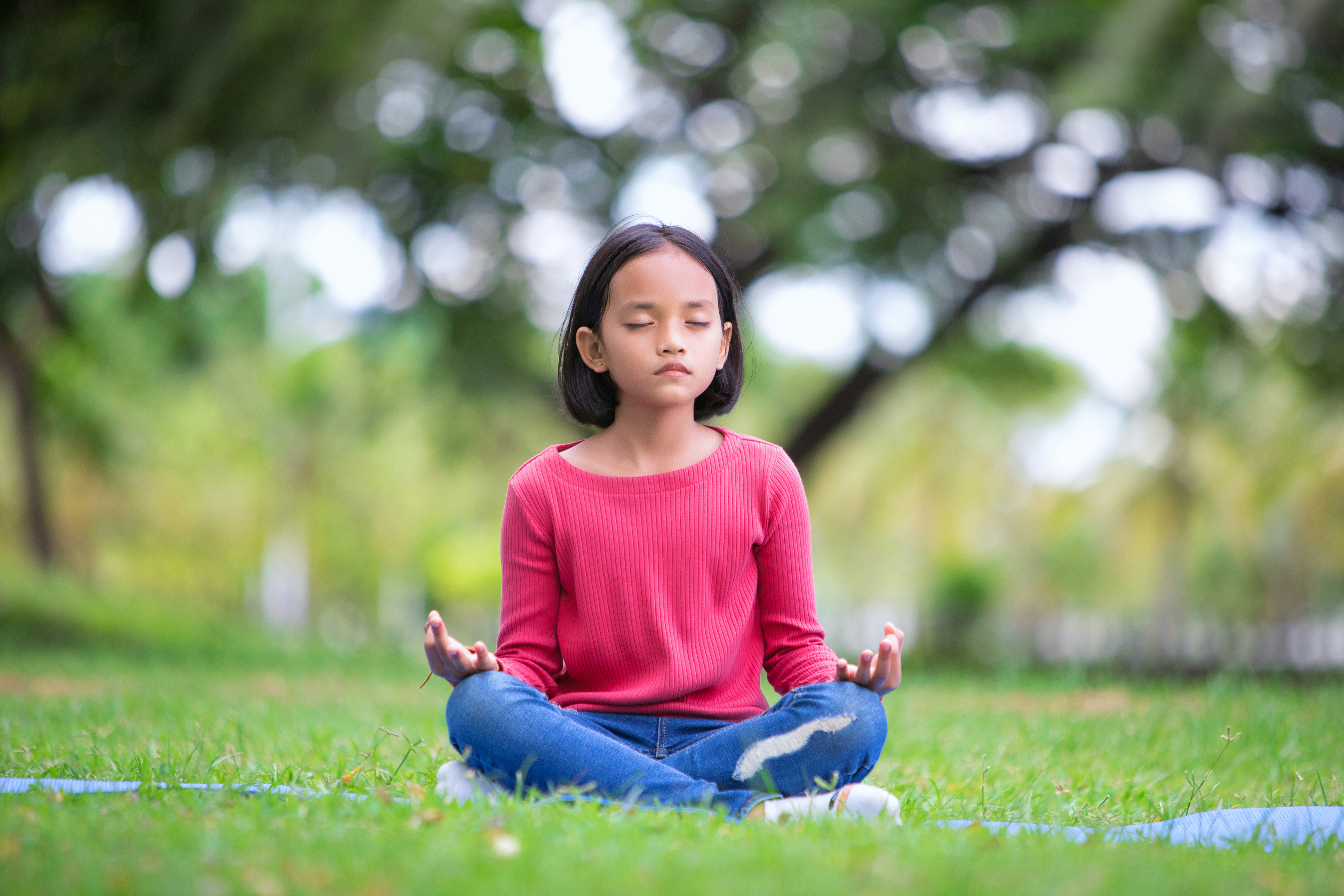 asian girl doing yoga pose in the park outdoor