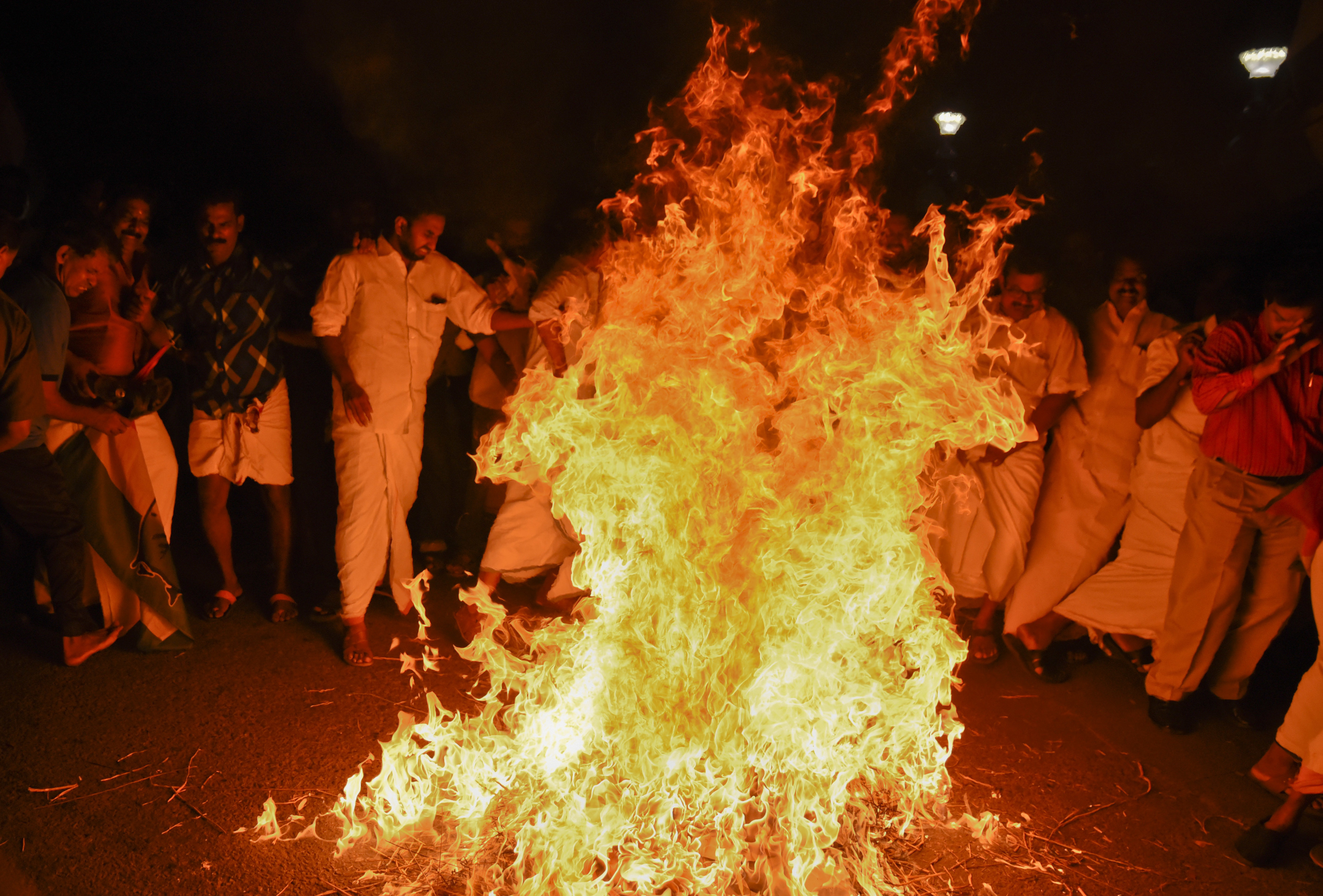 Opposition party activists burn an effigy of Chief Minister Pinarayi Vijayan after two women entered the Sabarimala temple in Thiruvananthapuram, Kerala, India