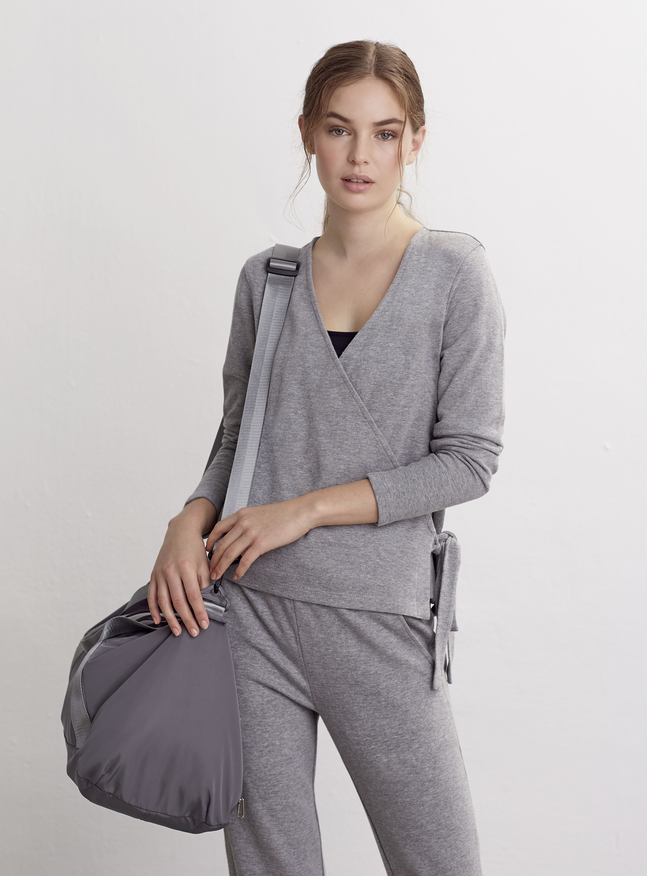 model wearing FatFace Athleisure Marnie Ballet Wrap Top; Athleisure Esme Tapered Joggers