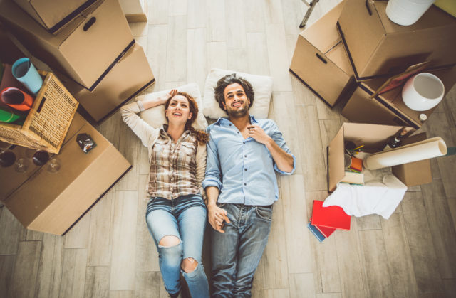 Young couple moving in into new apartment