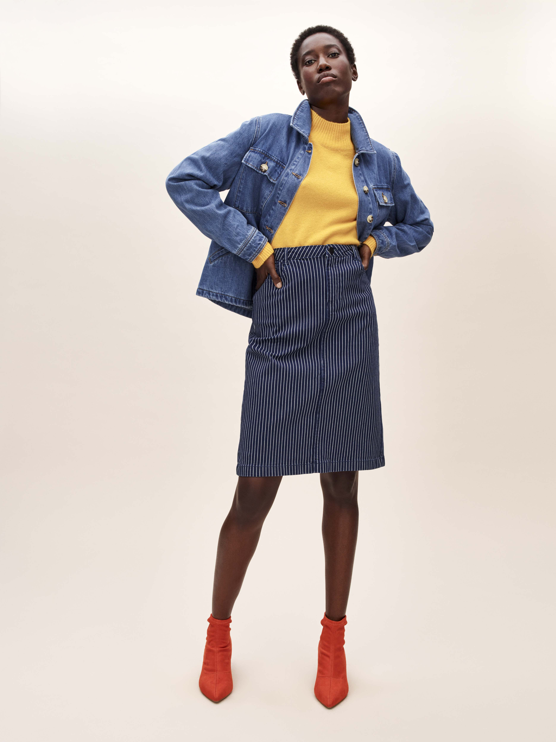 model weaing Tu at Sainsbury's Denim Jacket; Yellow Roll Neck Jumper; Stripe Pencil Skirt; Online Exclusive Orange Sock Ankle Boots
