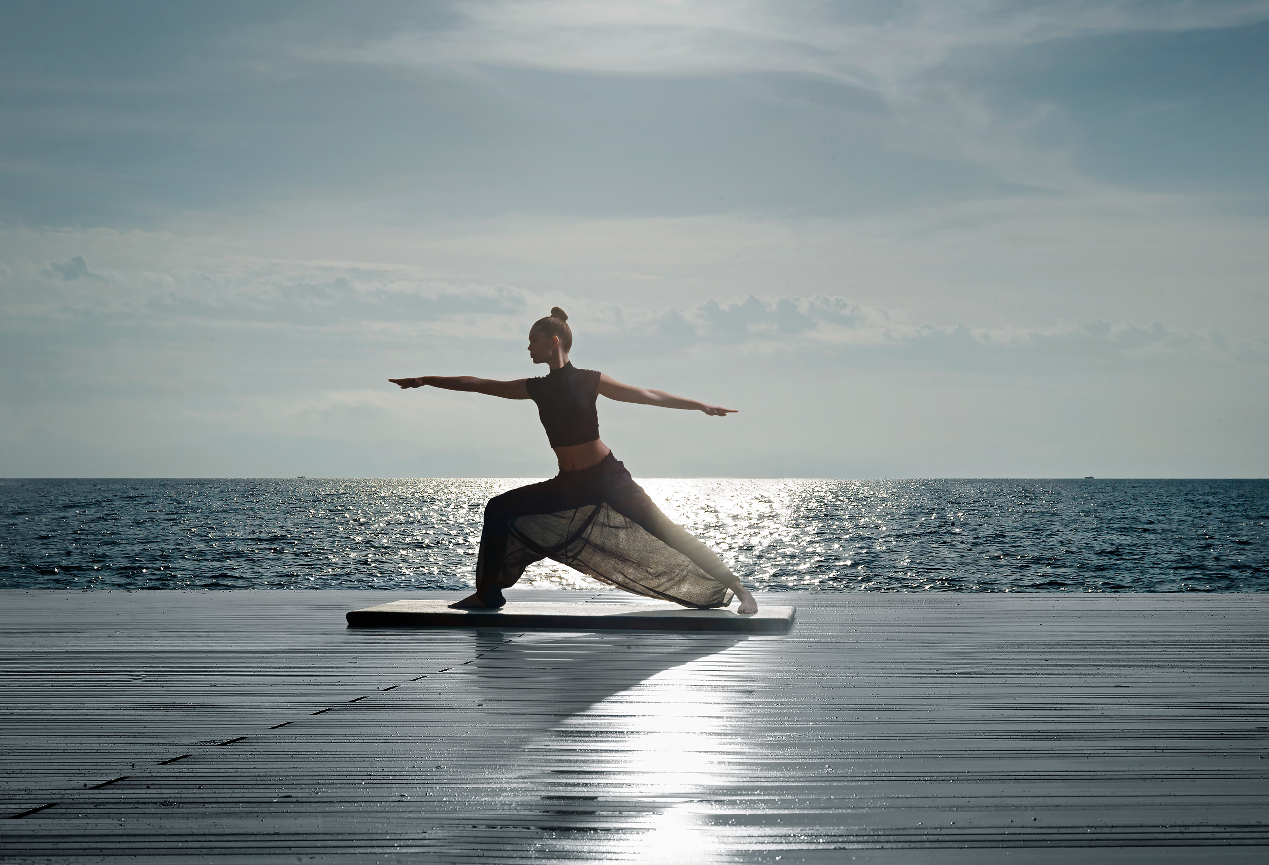 A woman doing yoga on the beach