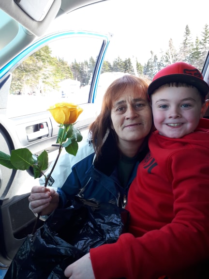 Casey giving a rose to a women from his family's car