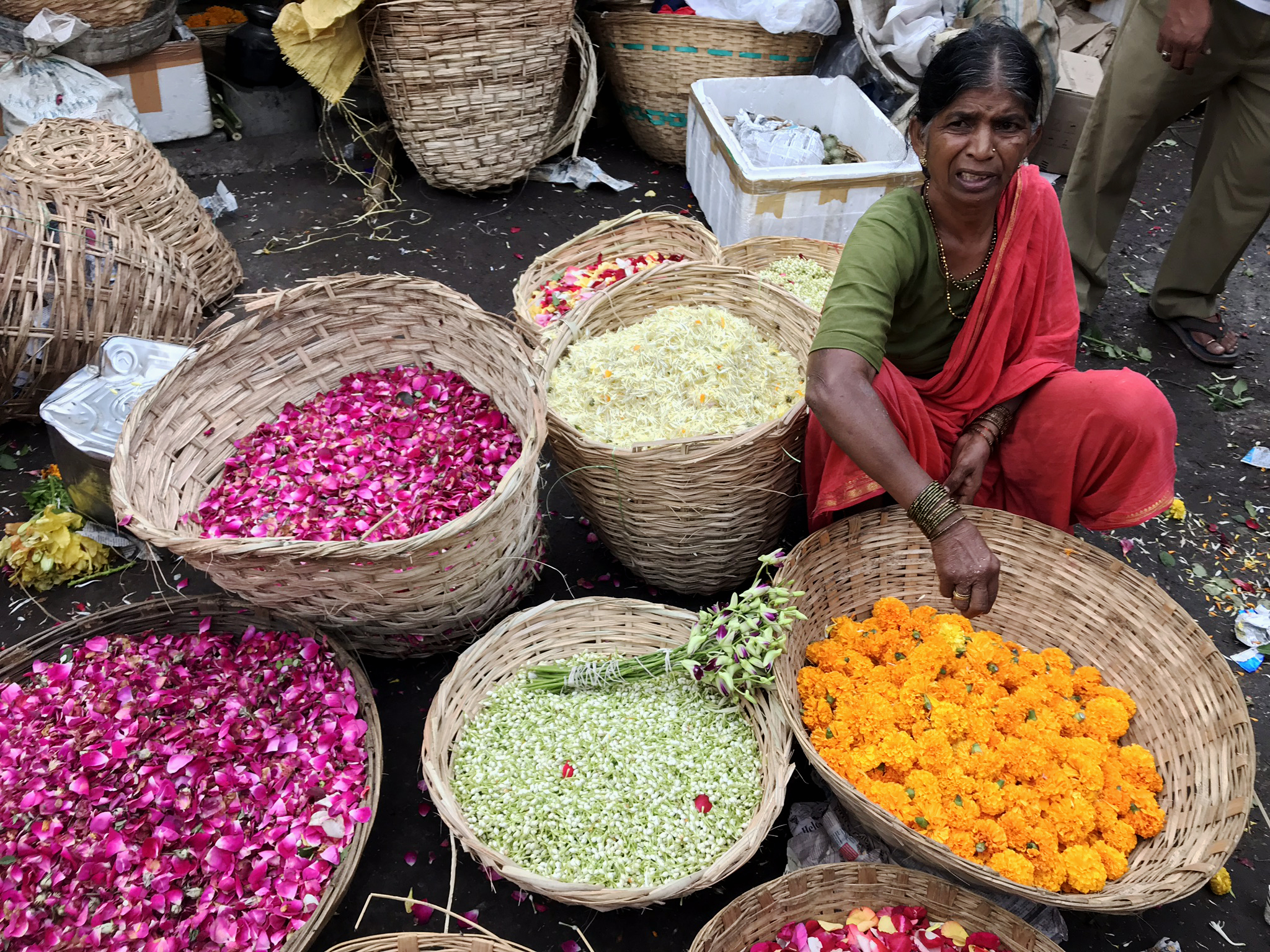 A lady sells flowers at the Dadar Flower Market (Harriet Line/PA)