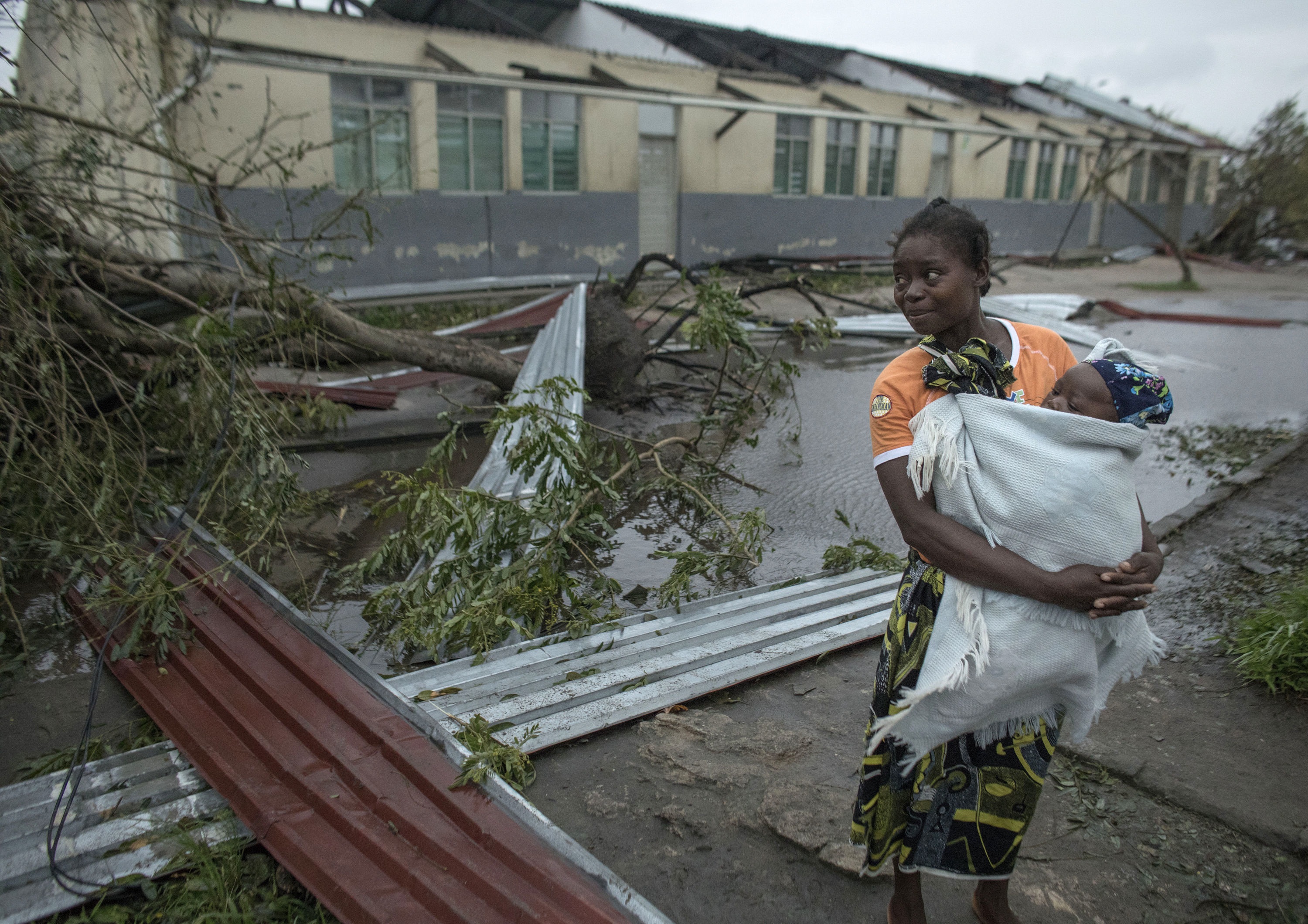 A woman makes her way to a school building being used as an emergency shelter