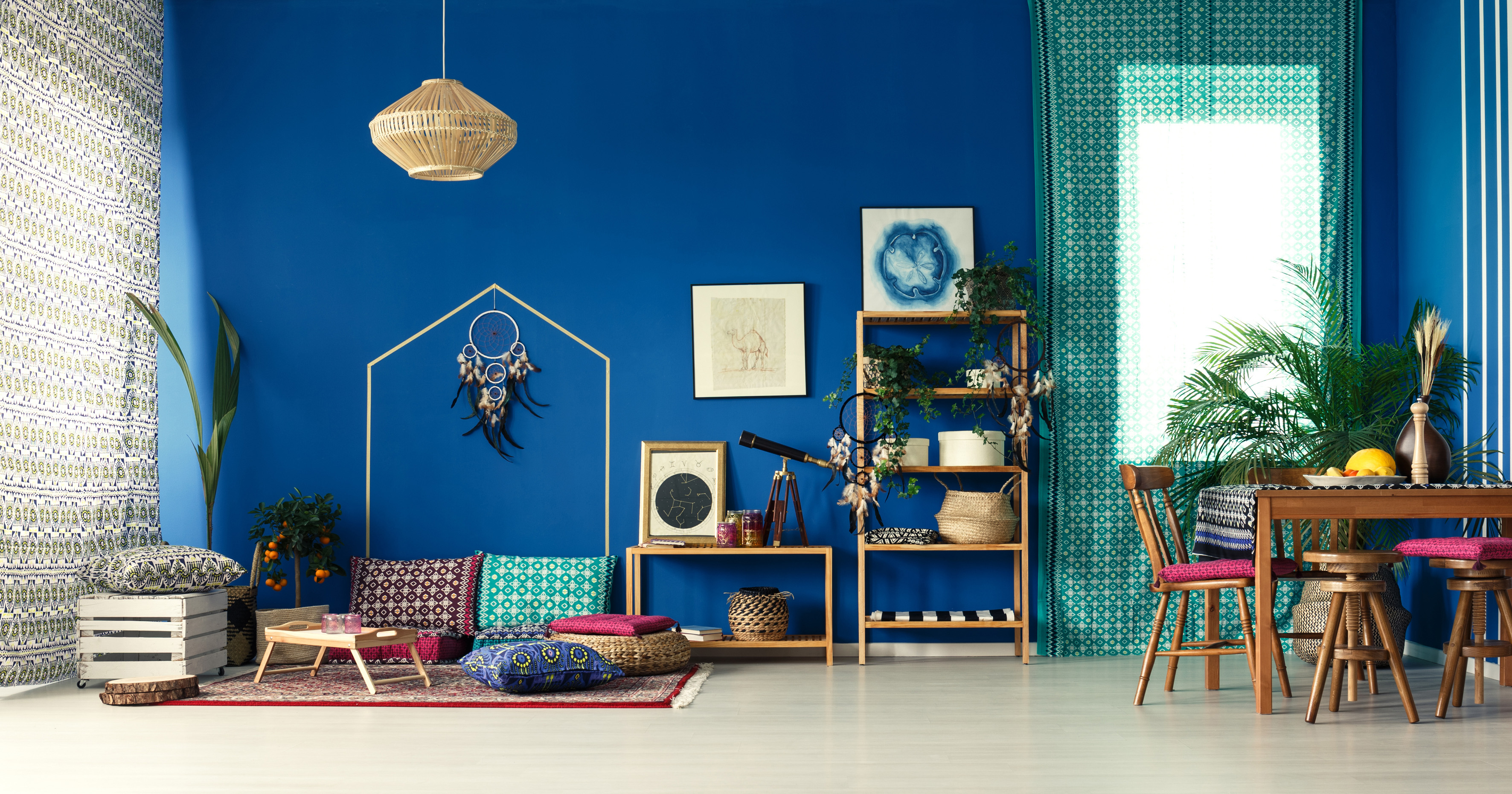 Bohemian home interior with cobalt blue wall and bright green plants to suit an outgoing Leo (ScS/PA)