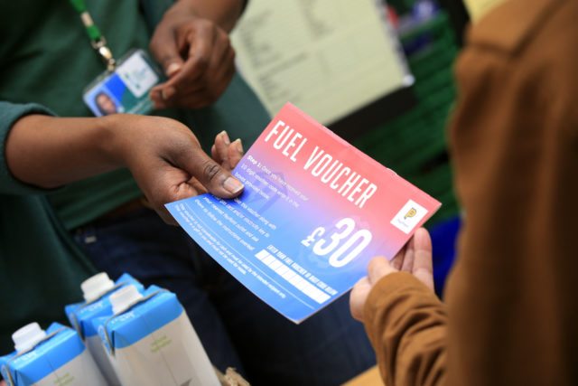 A fuel voucher being handed over