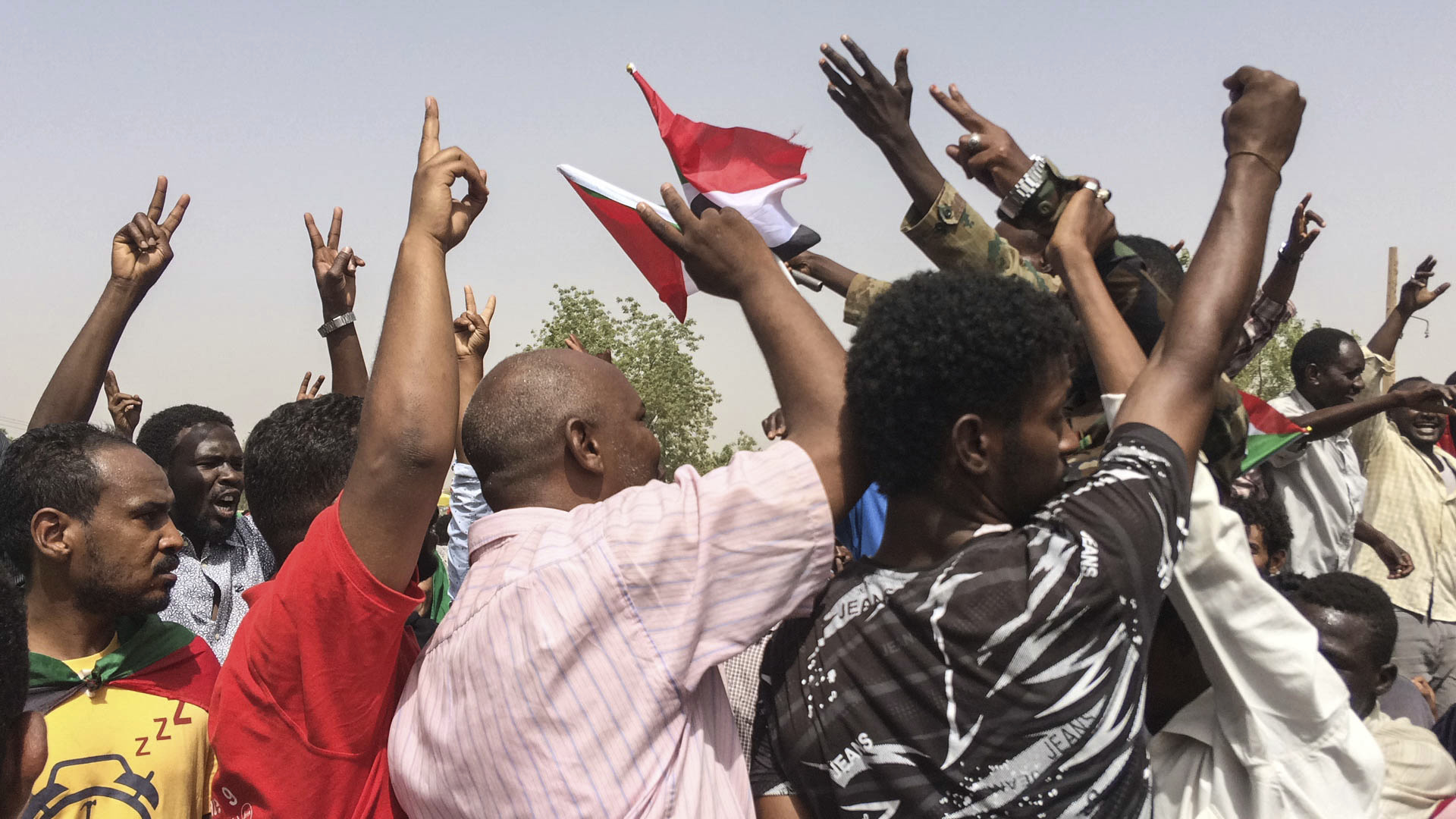 Sudanese celebrate after officials said the military had forced longtime autocratic President Omar al-Bashir to step down after 30 years in power in Khartoum, Sudan