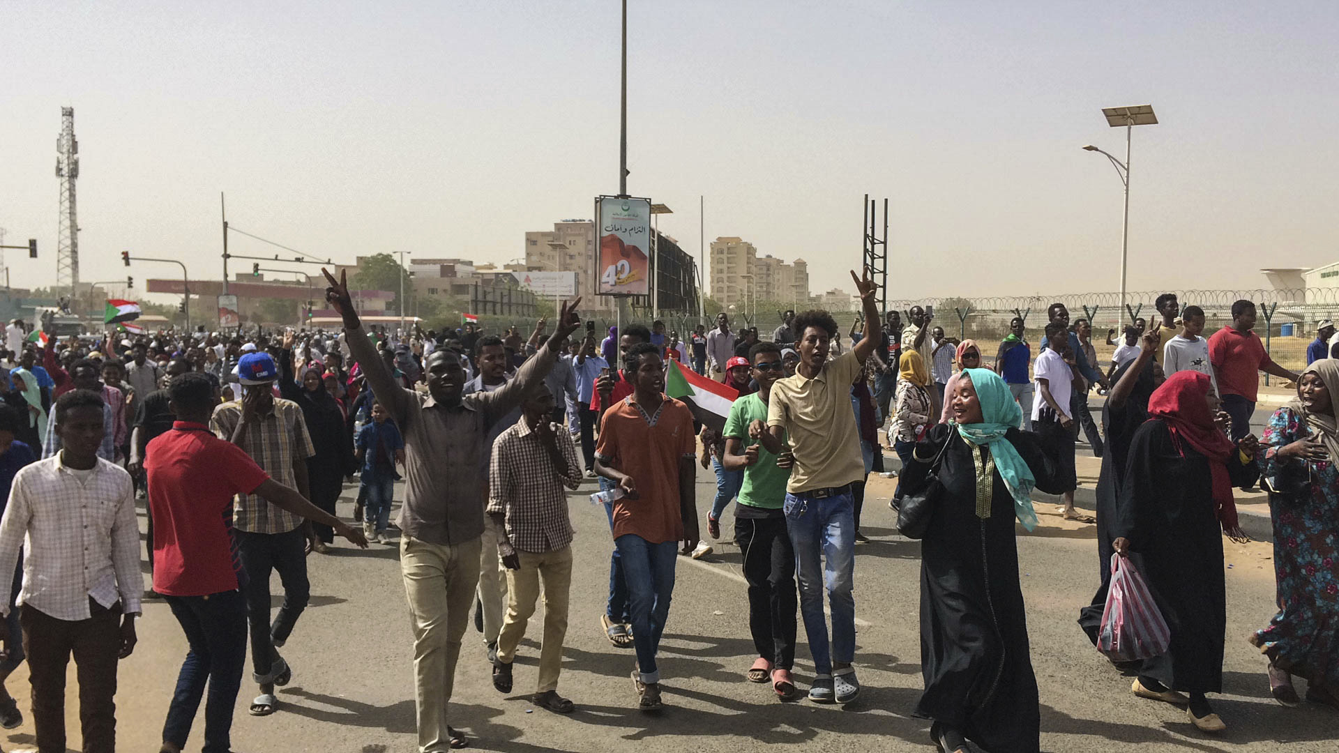Sudanese celebrate after officials said the military had forced longtime autocratic President Omar al-Bashir to step down after 30 years in power in Khartoum