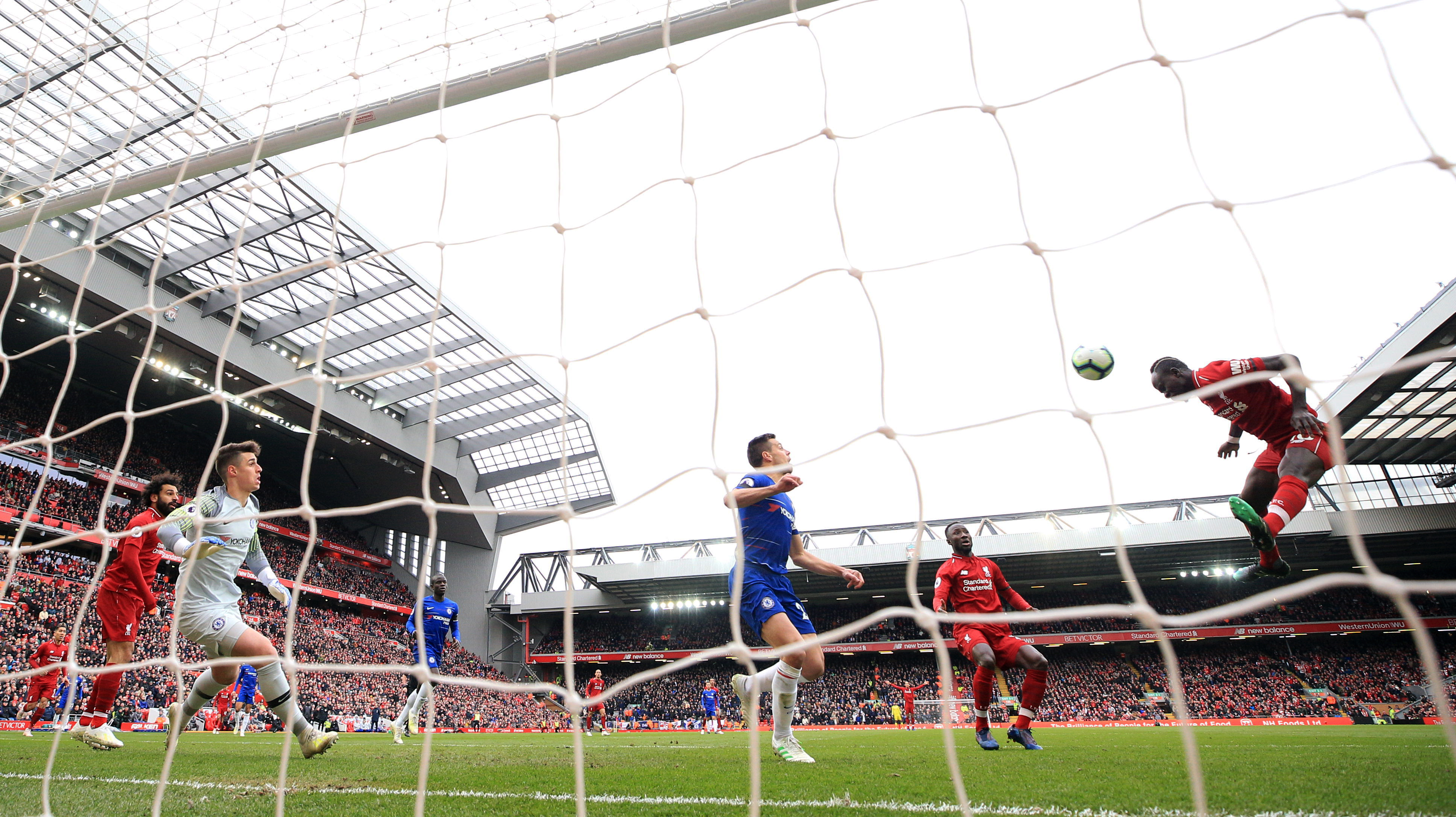 Liverpool's Sadio Mane (right) scores his side's first goal of the game during the Premier League match against Chelsea at Anfield, Liverpool