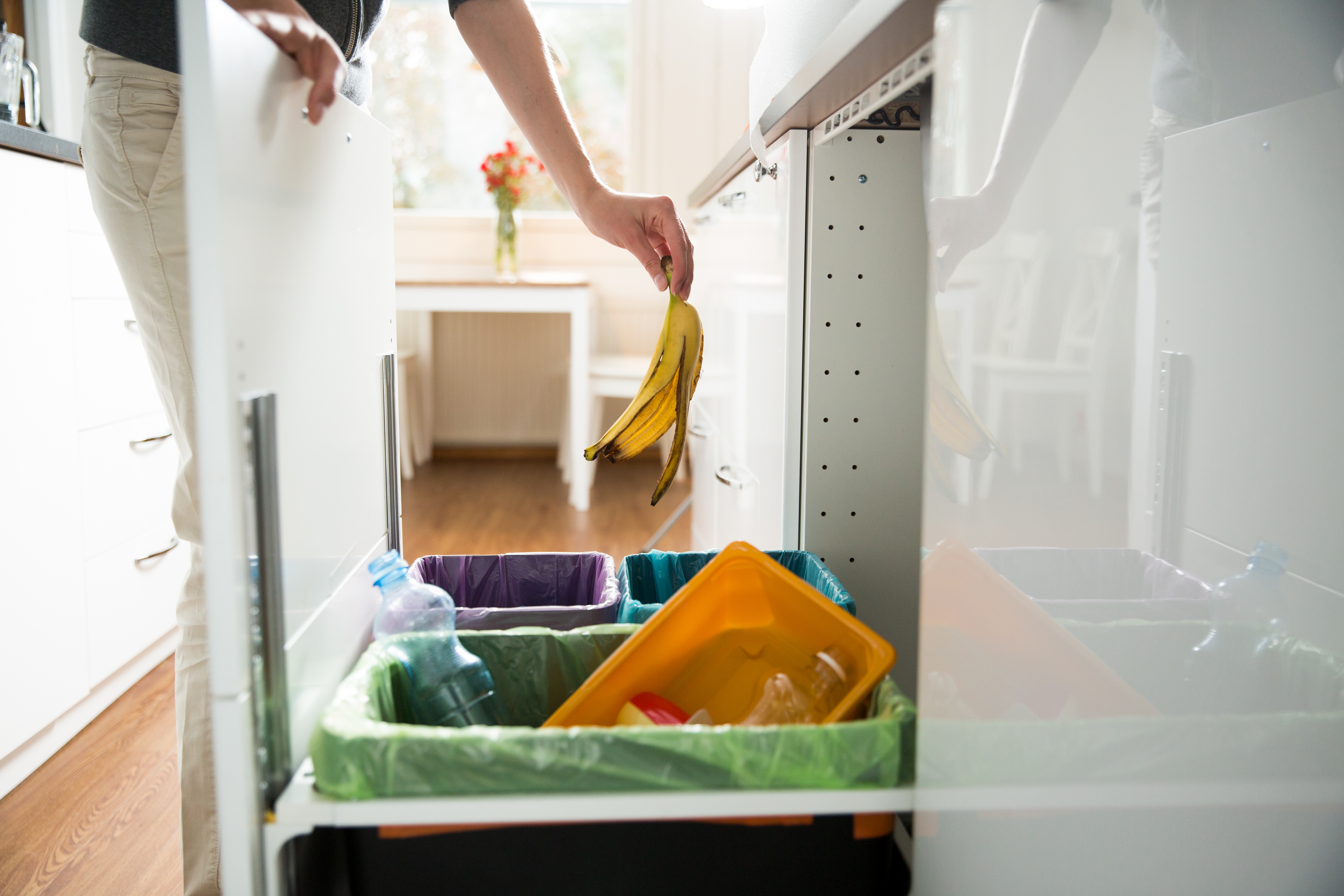 A Generic Photo of a woman putting a banana peel in the bin (iStock/PA)
