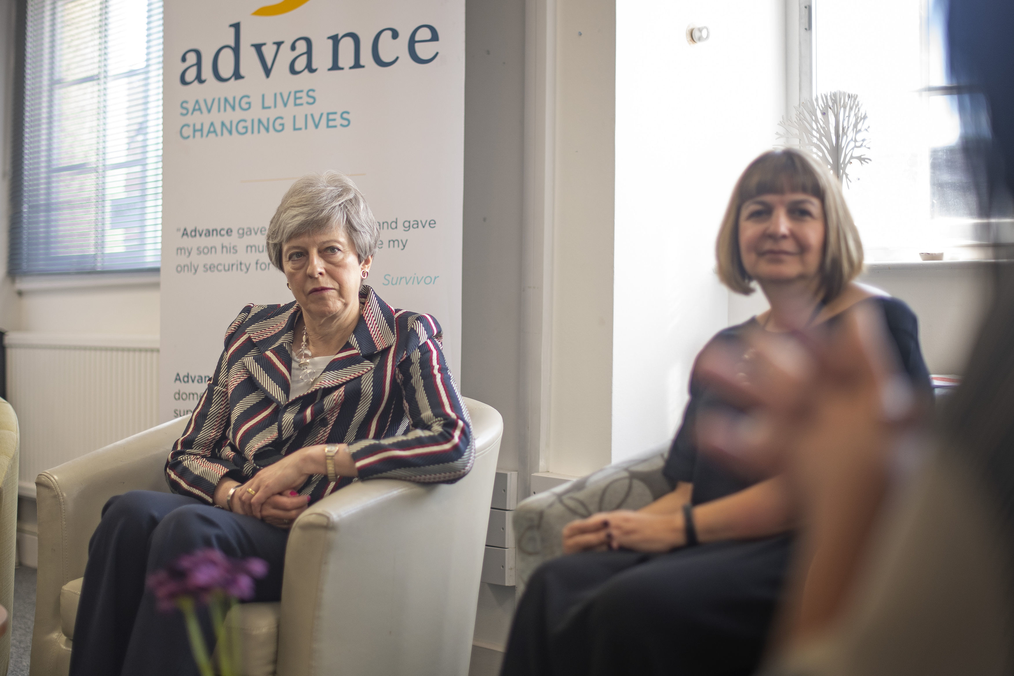 Theresa May, left, talks with Advance CEO Niki Scordi