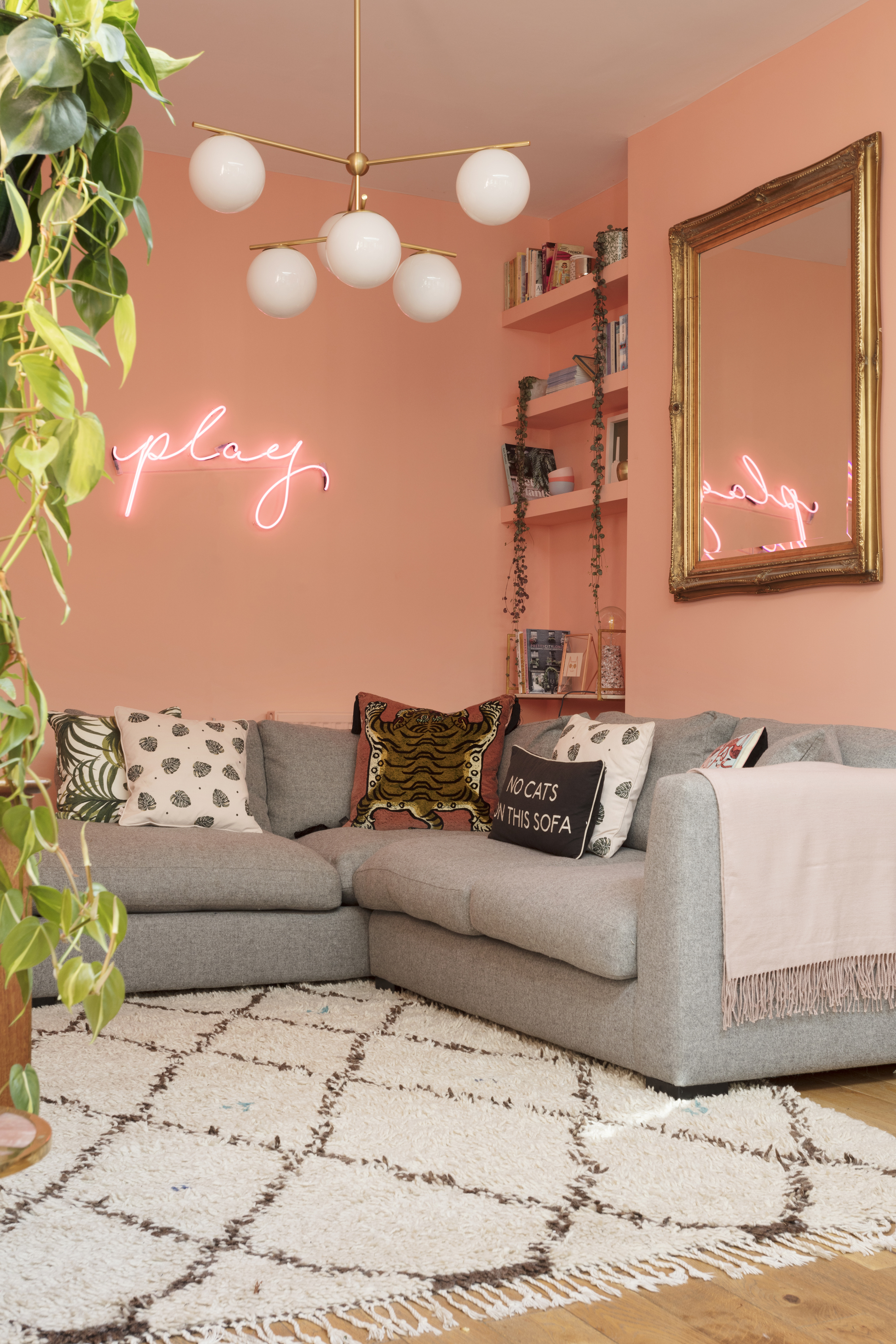 Emily Murray's living room painted in a vibrant peachy pink. ((Susie Lowe/Ryland Peters & Small/PA)