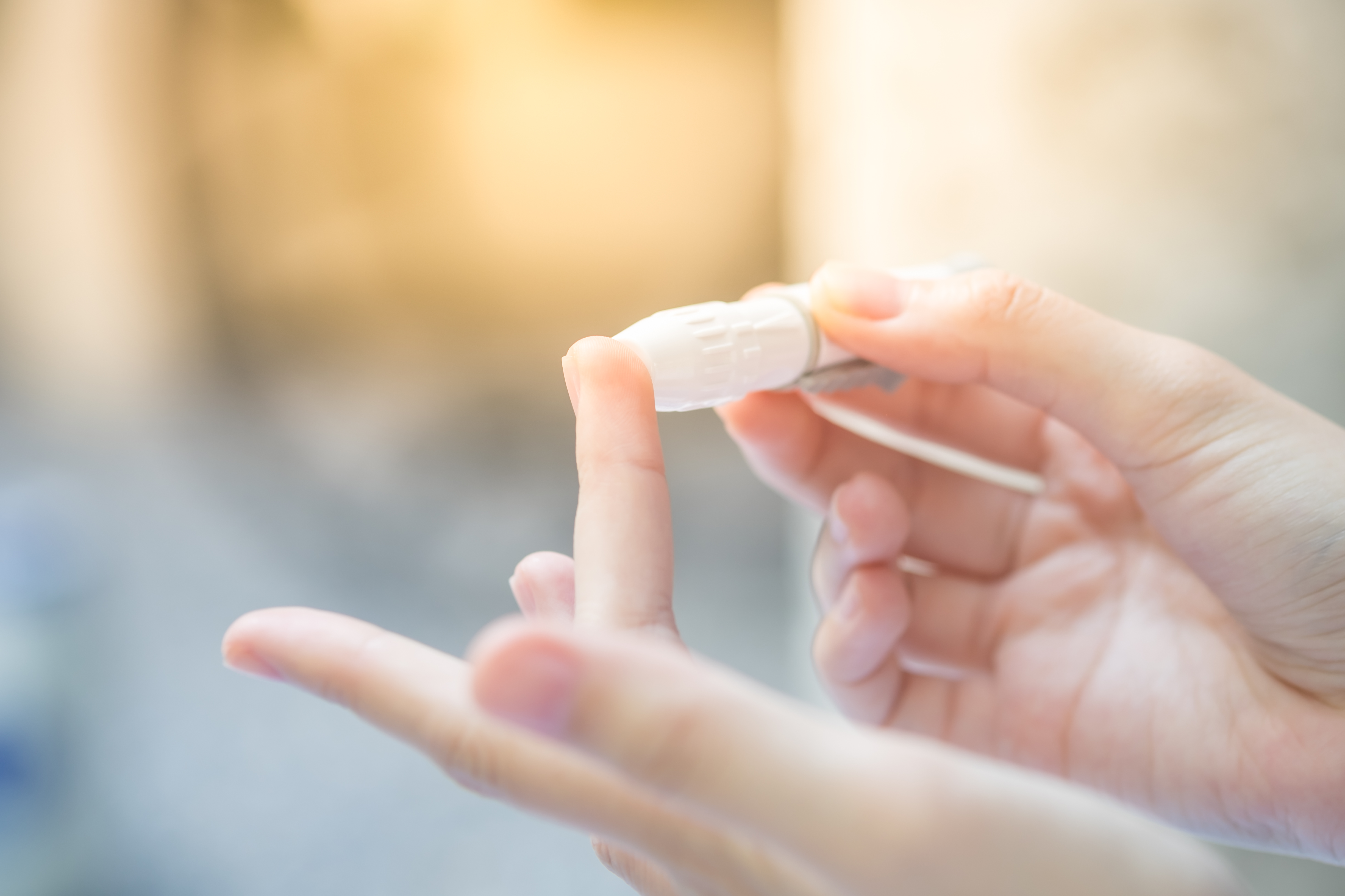Woman having finger prick test