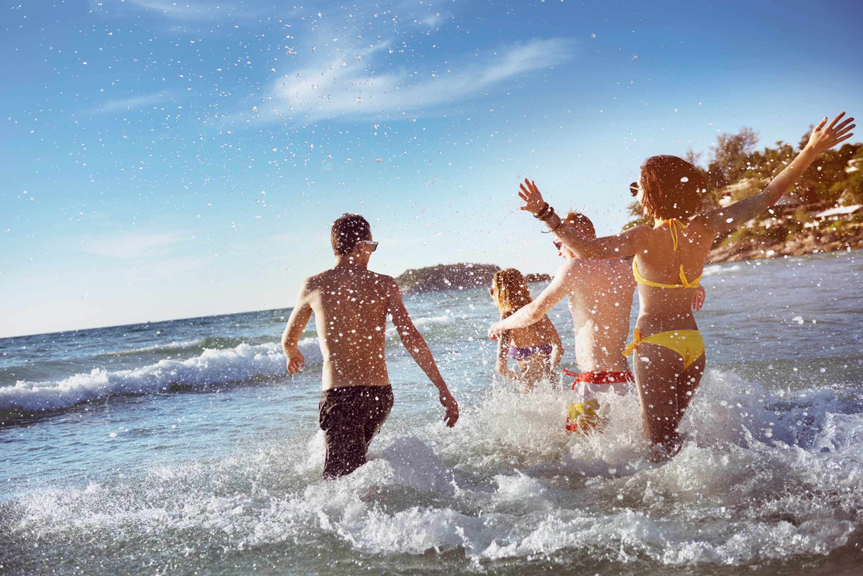 people running into the sea