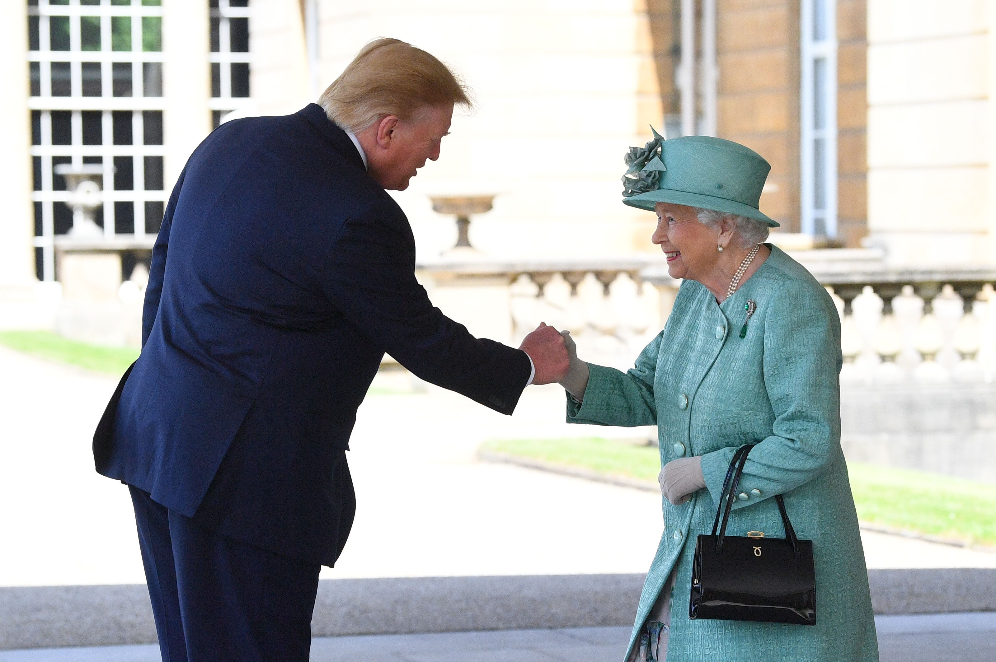 Mr Trump shakes hands with the Queen