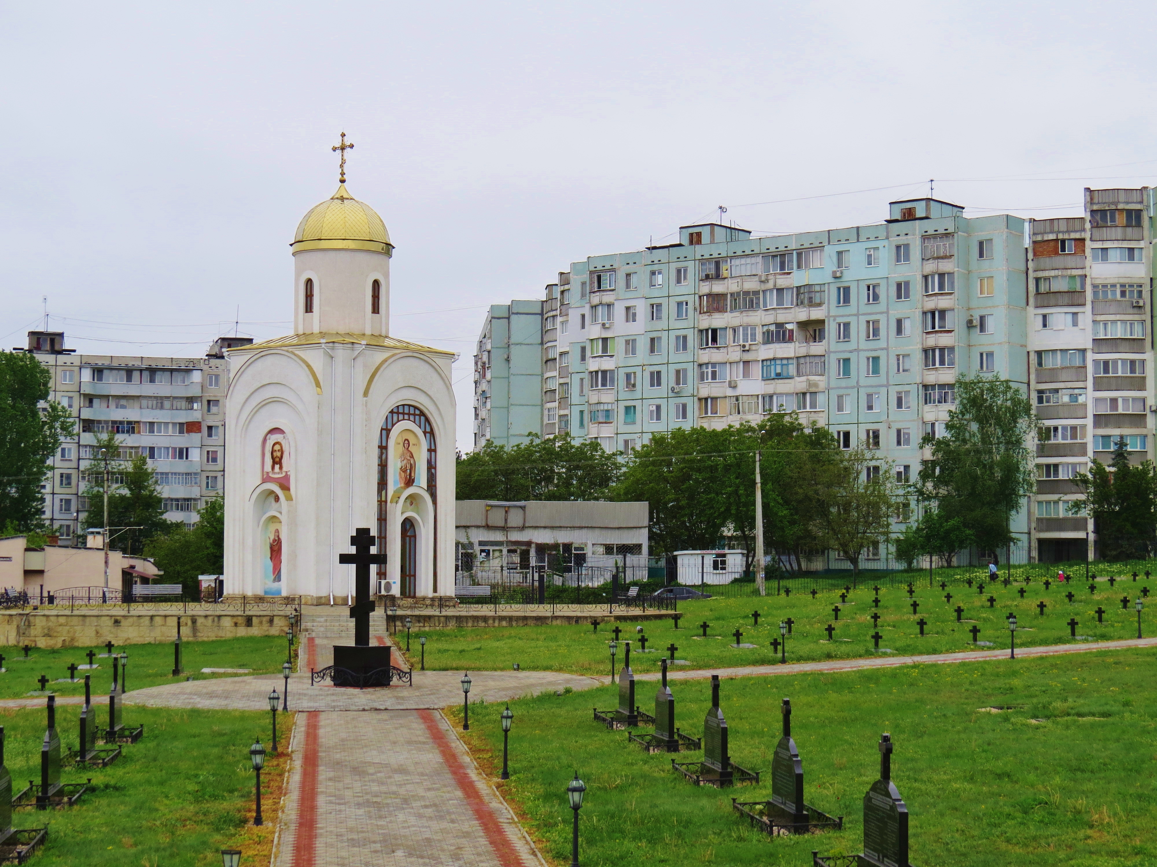 A church next to Soviet-era blocks in Bender, Transnistria