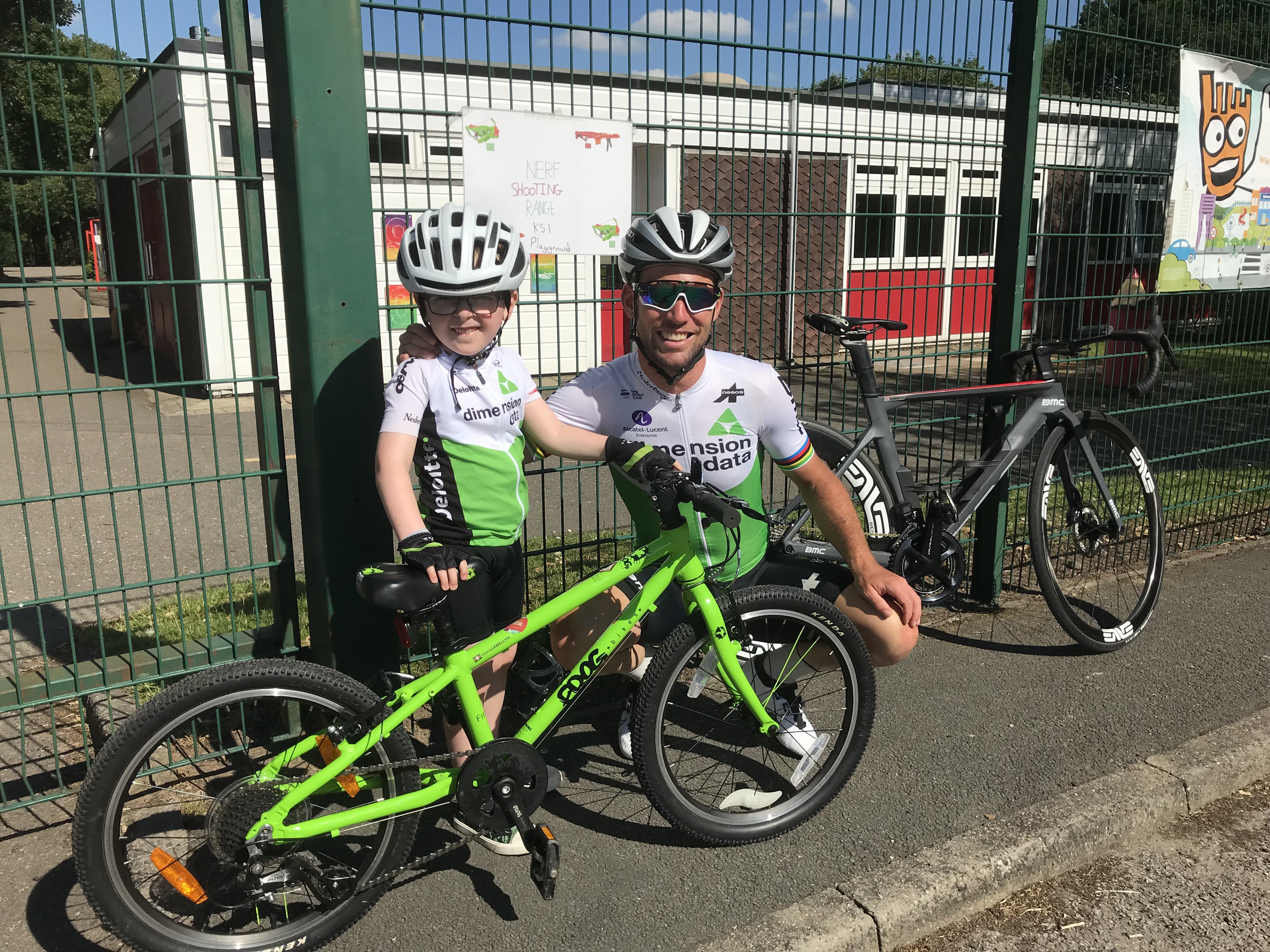 Mark Cavendish poses for a photo with cycling fan Evan Llewellyn