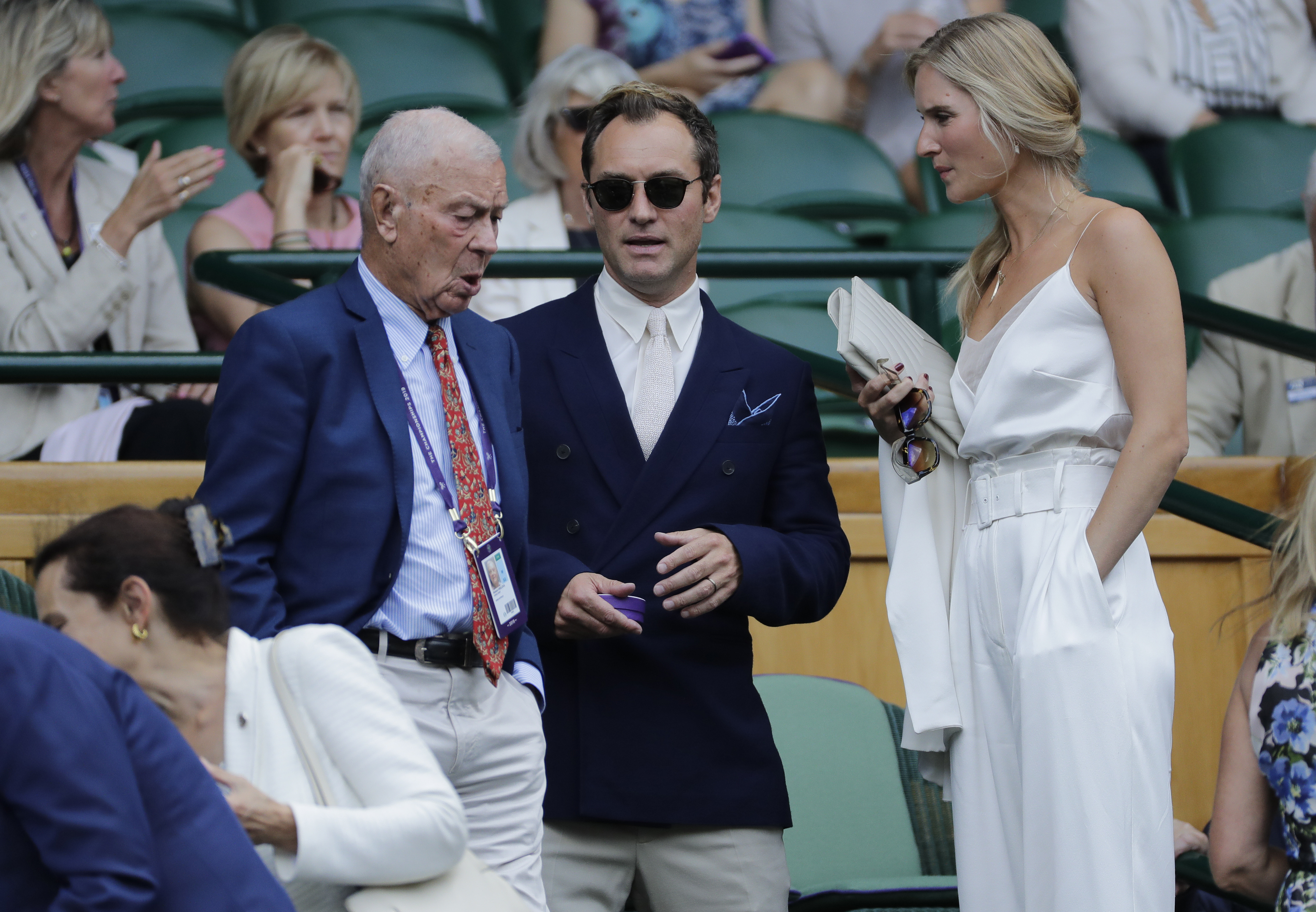 Actor Jude Law, center, and his wife Phillipa Coan arrive in the Royal Box on Centre Court to watch a Men's singles semifinal match