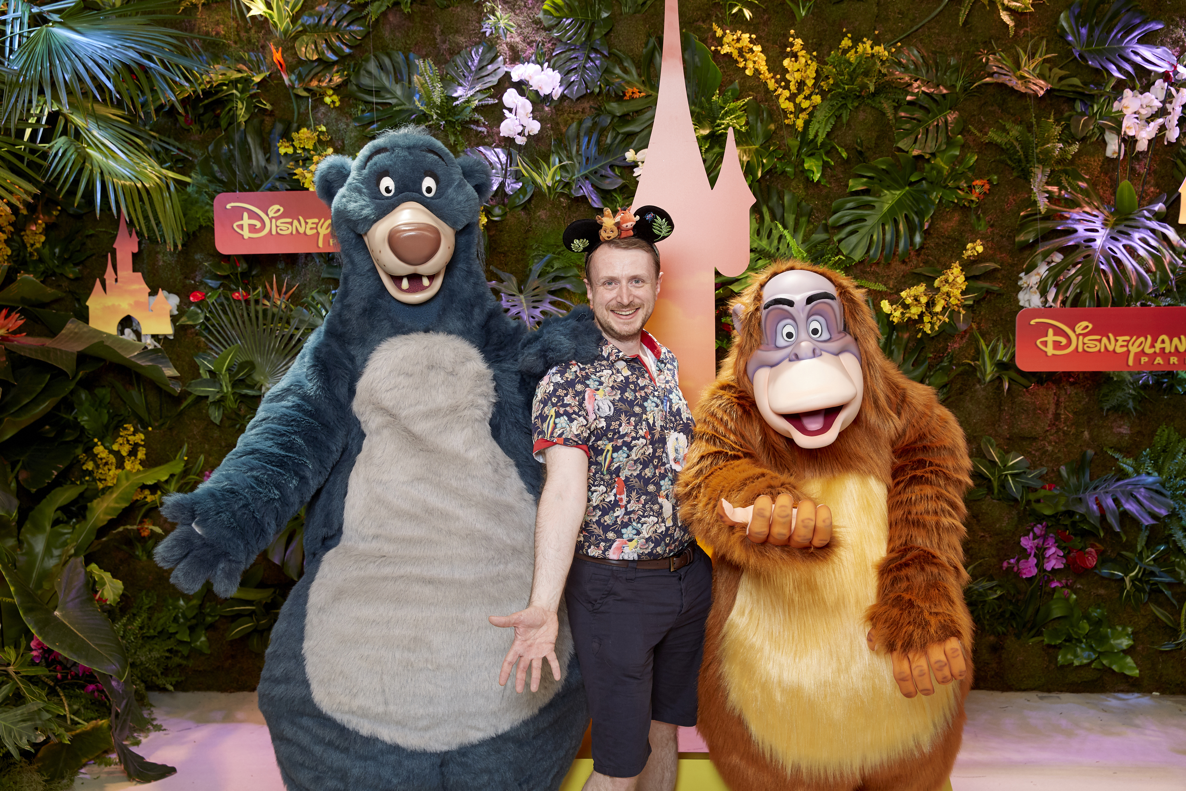 Damon Smith celebrates with Baloo and King Louie at Disneyland Paris (Disney/PA)