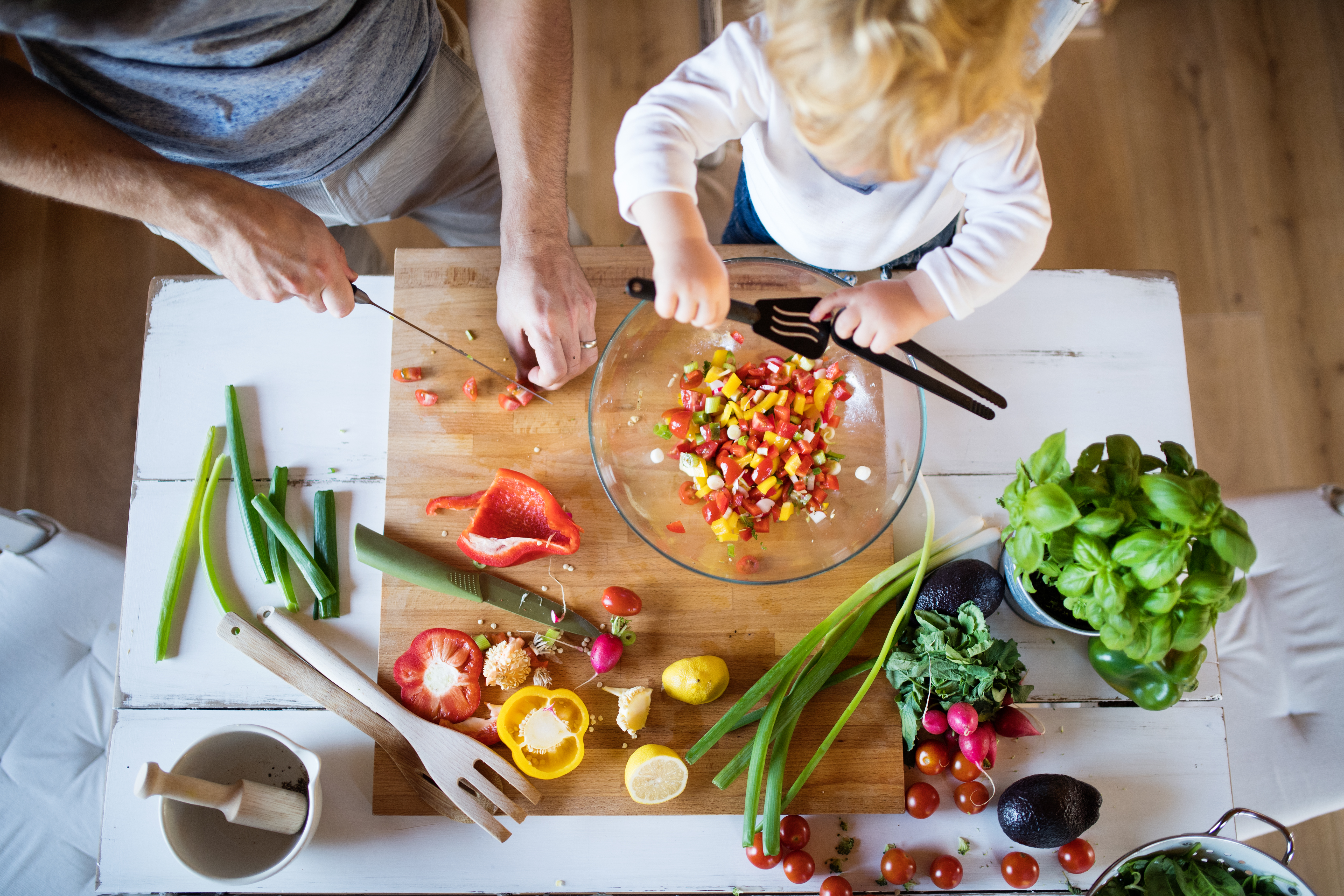 Dada and toddler making veg