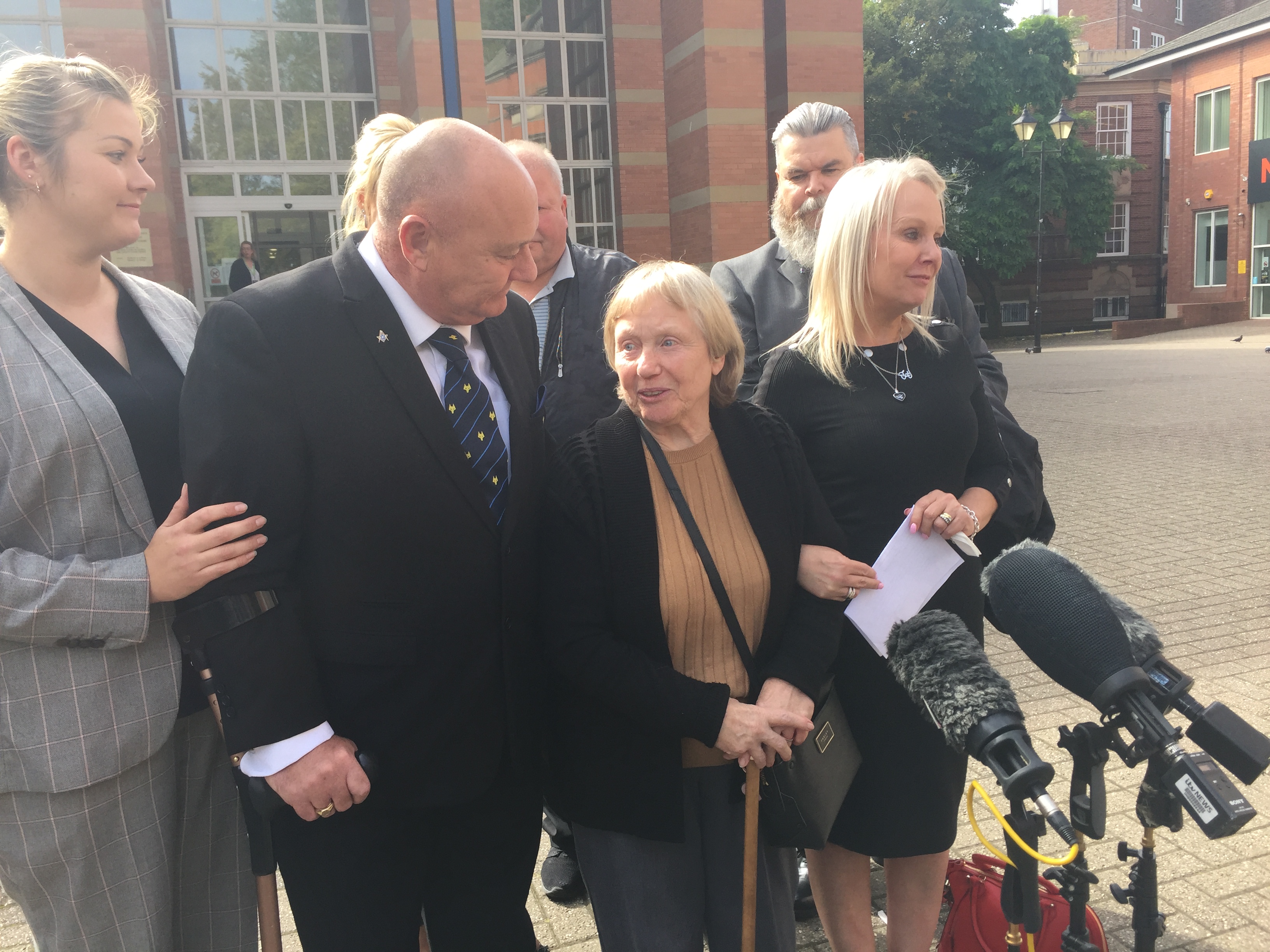 Mavis Eccleston outside Stafford Crown Court after her acquittal, flanked by her daughter Joy and son Kevin