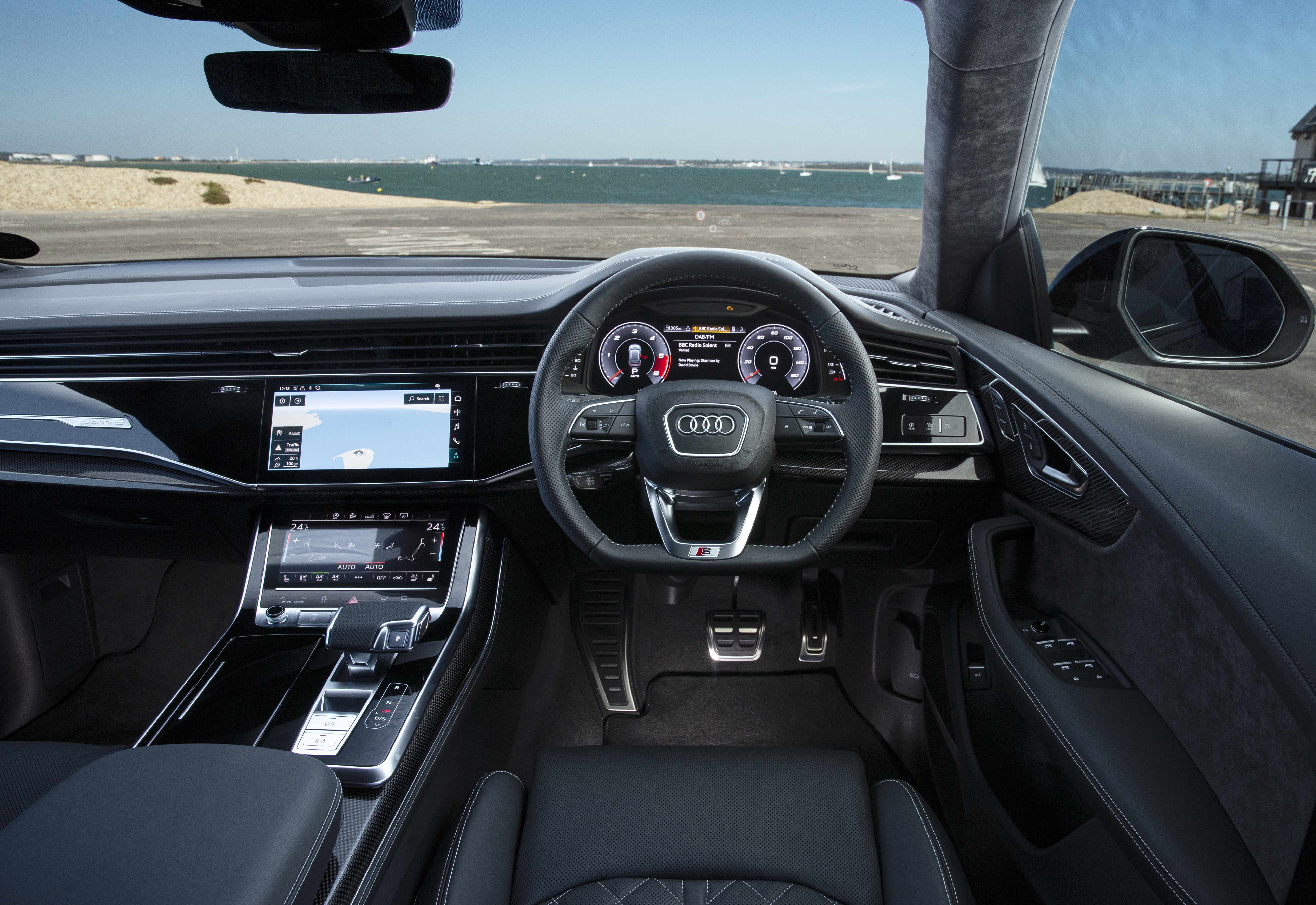 The interior is dominated by a twin screen infotainment system