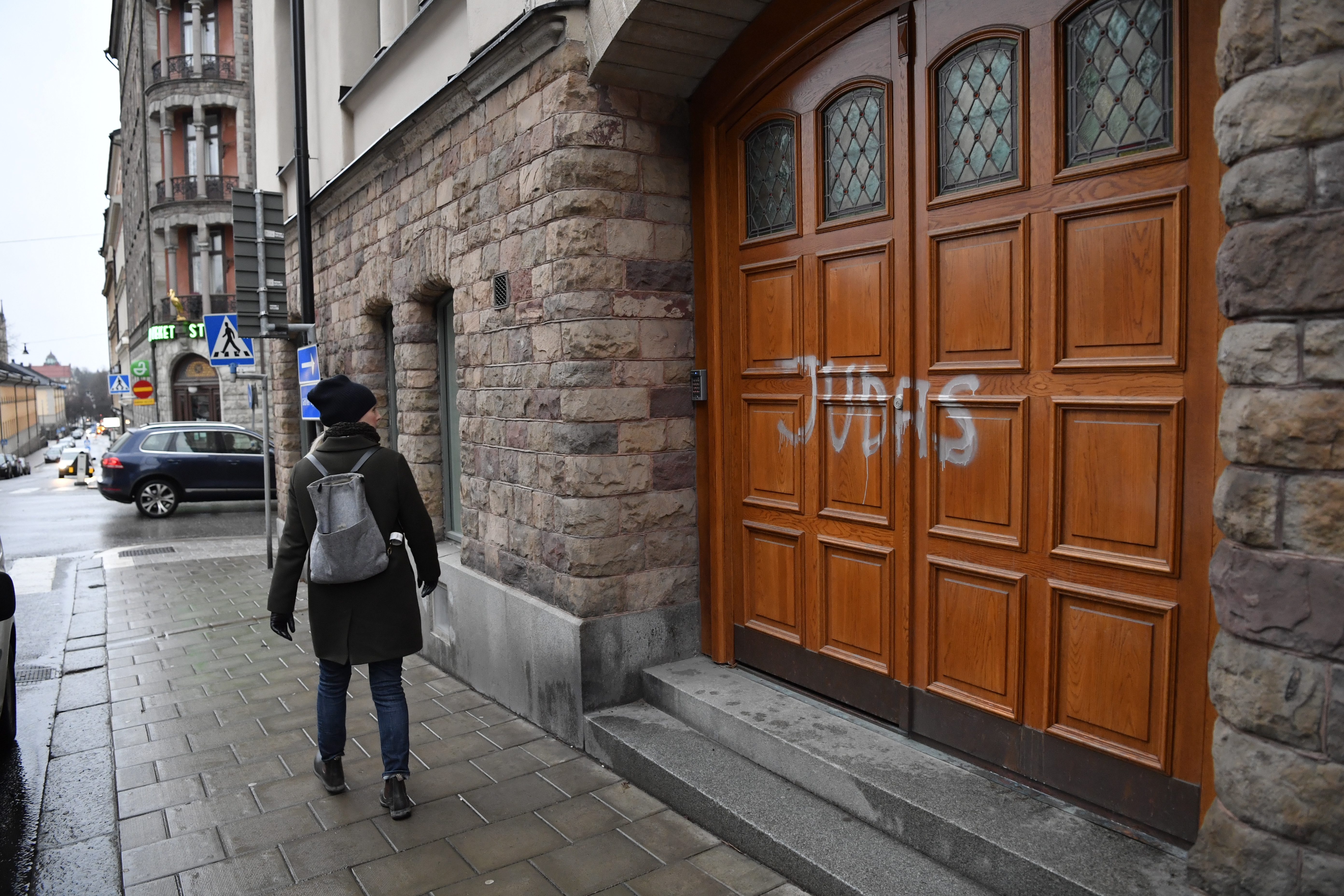 Someone walks past the word "Judas" written on the door of Swedish football player Zlatan Ibrahimovic's residence in Stockholm