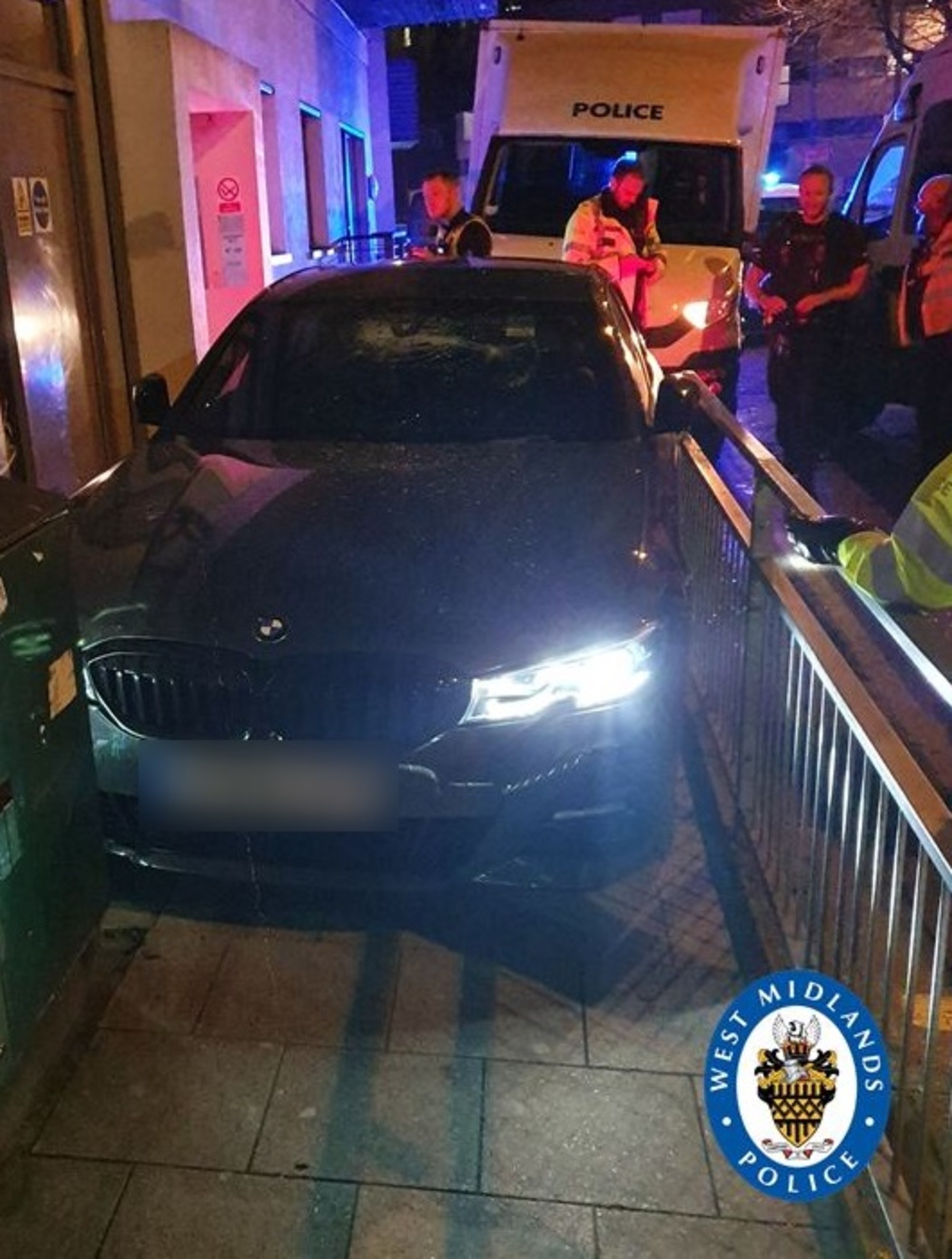 The BMW became pinned between railings