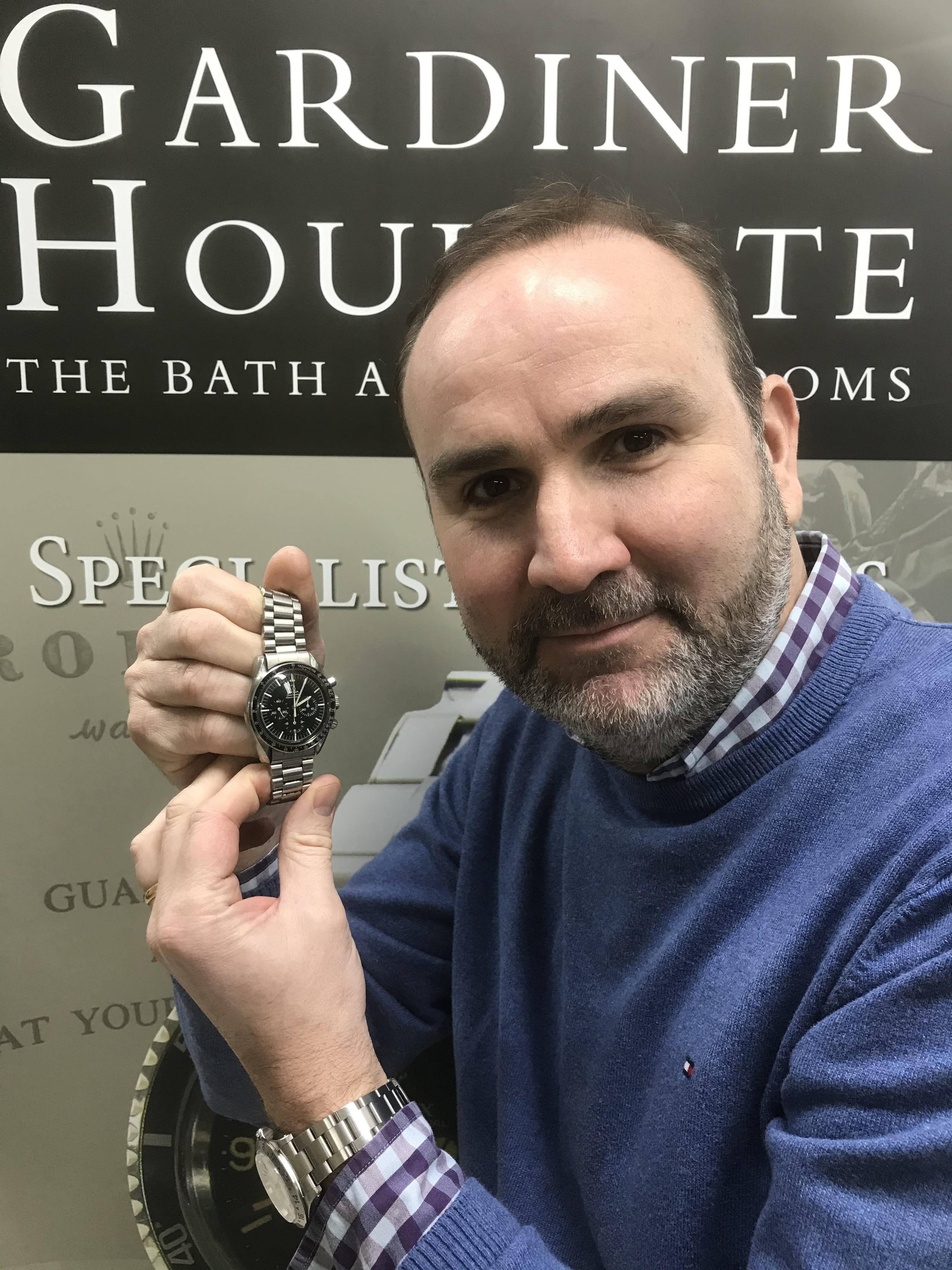 Auctioneer David Hare with the Omega Speedmaster watch