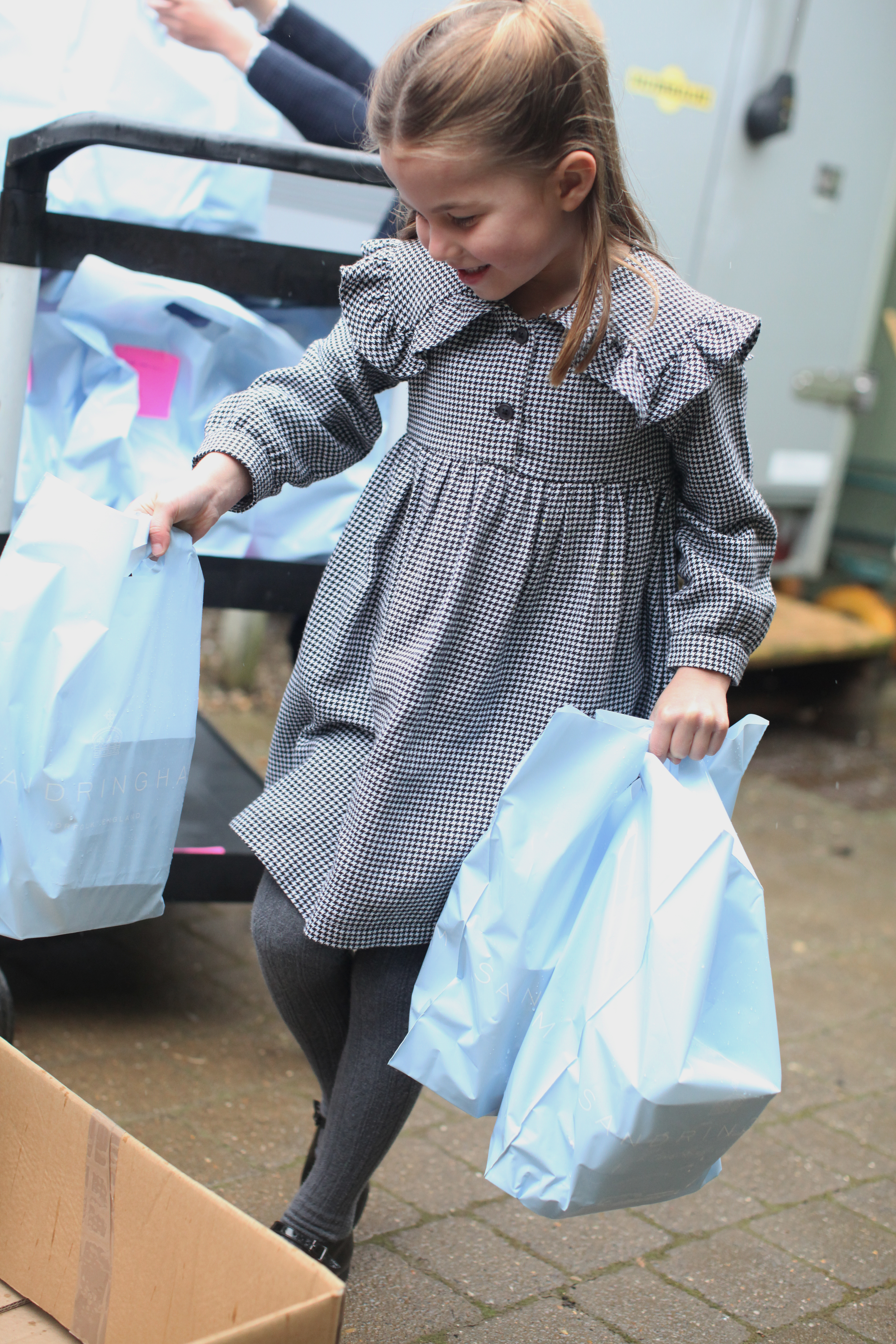 The young princess carrying bags of food for those in need. Duchess of Cambridge