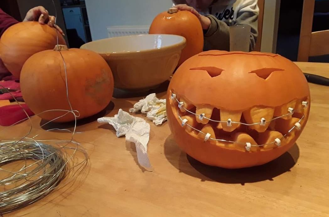 A pumpkin with braces on its teeth