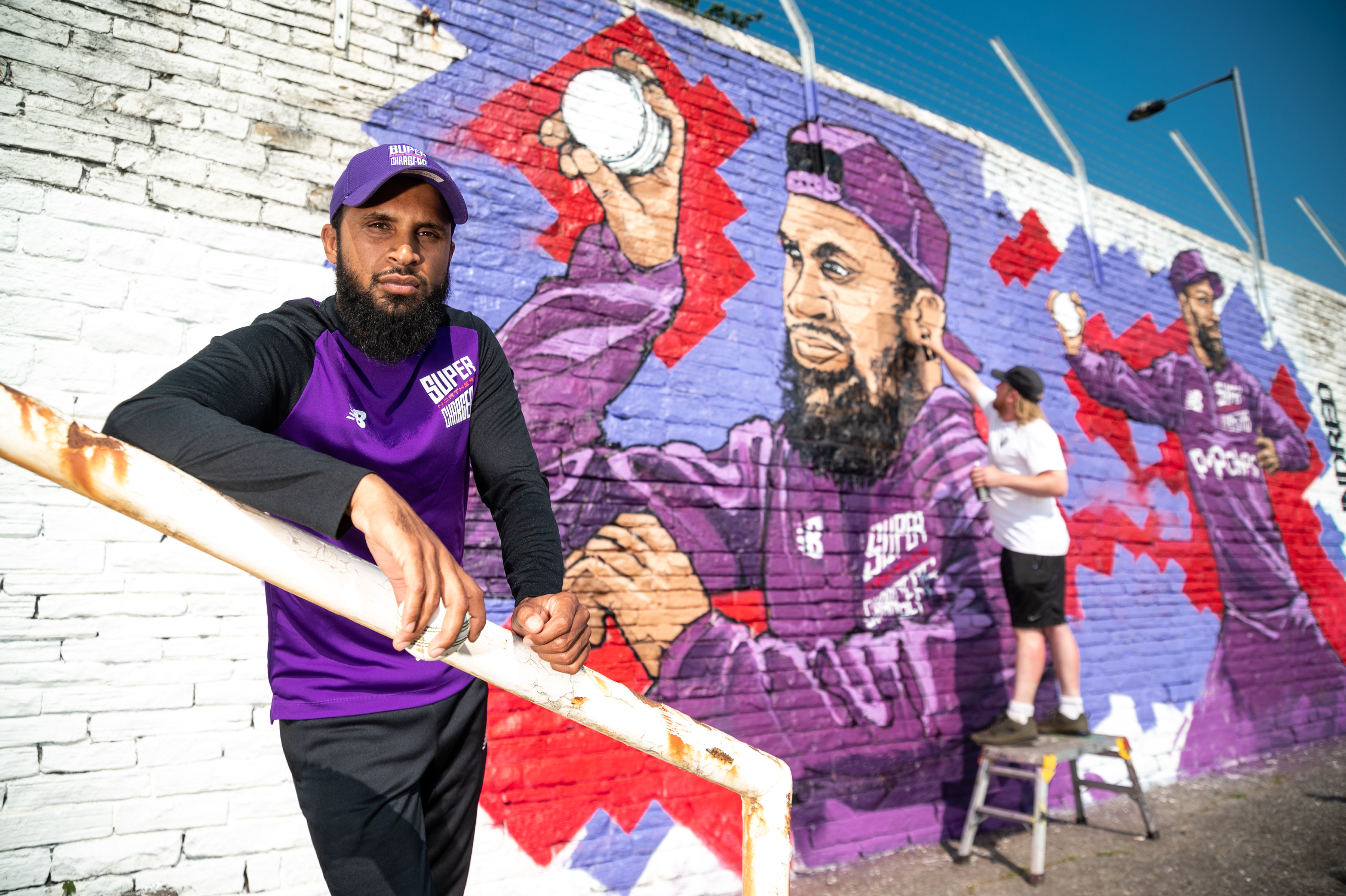 Rashid is the subject of a new mural by artist Adam Duffield (background). (Simon Dewhurst).