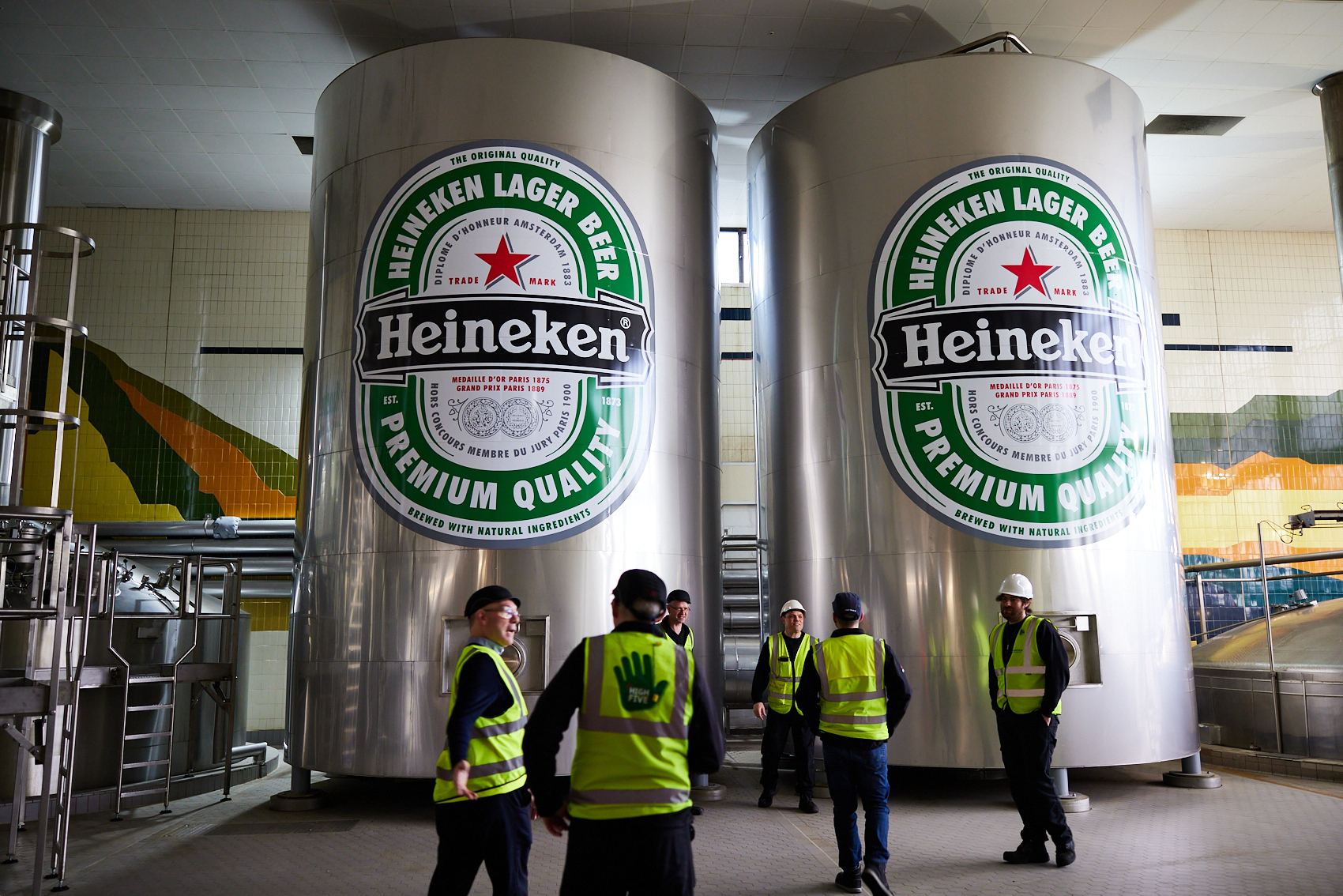 People stand around in a Heineken brewery