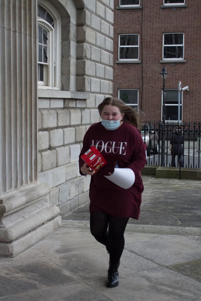 Girl walking with Easter egg in her hand and a mask on 