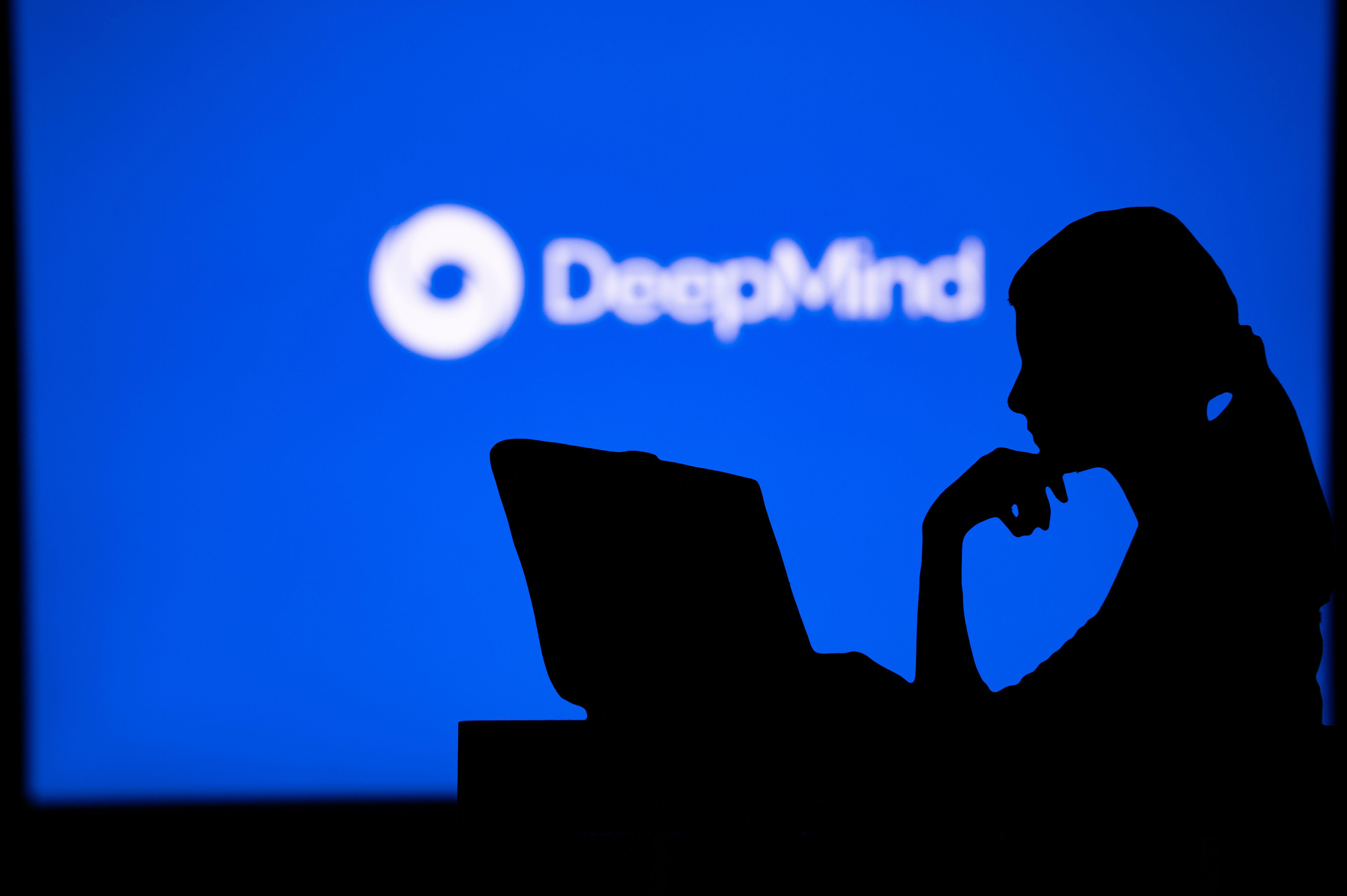 Woman working in front of DeepMind logo