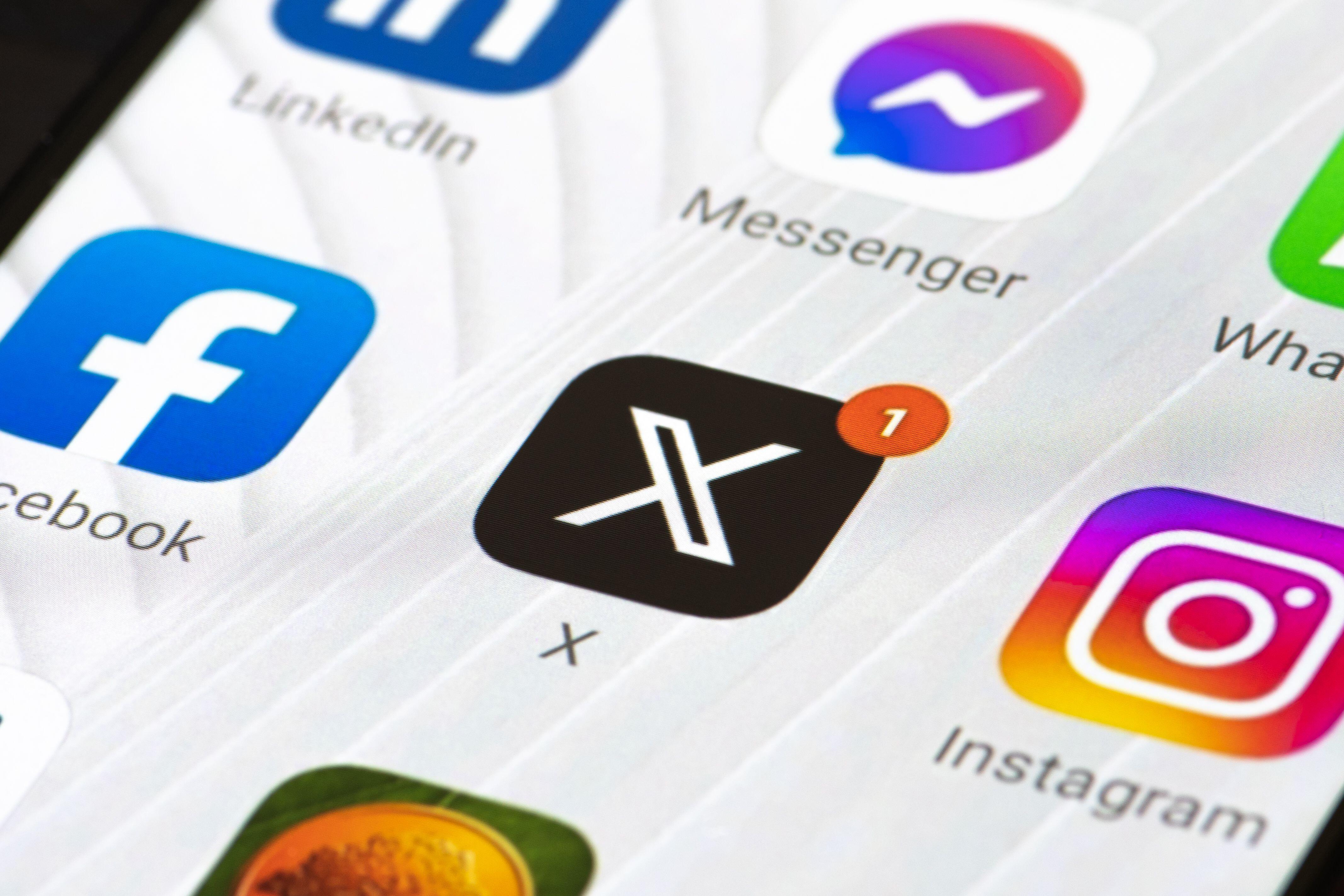 An X logo and app on a phone screen
