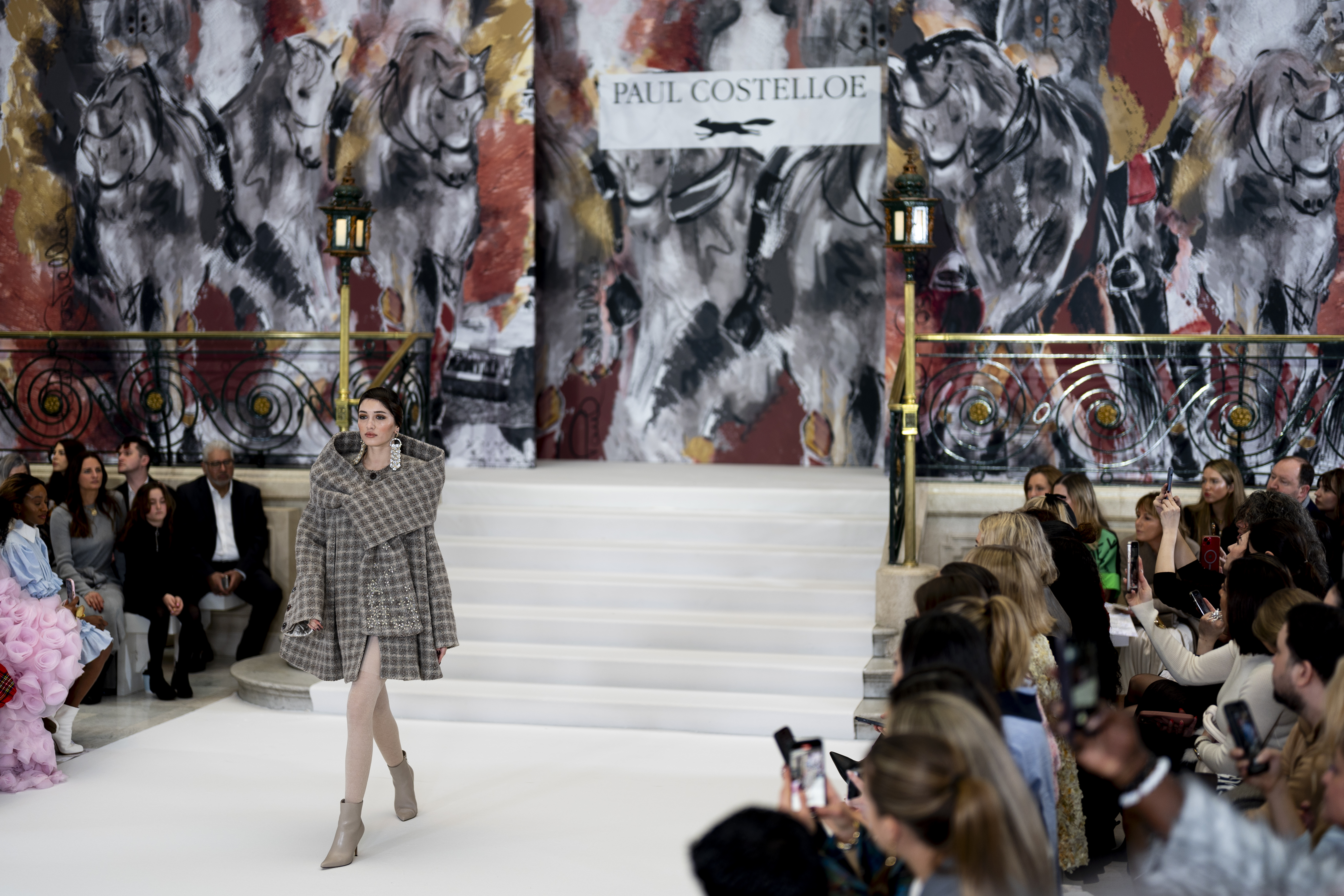 Model walks down runway in heritage tweed coat