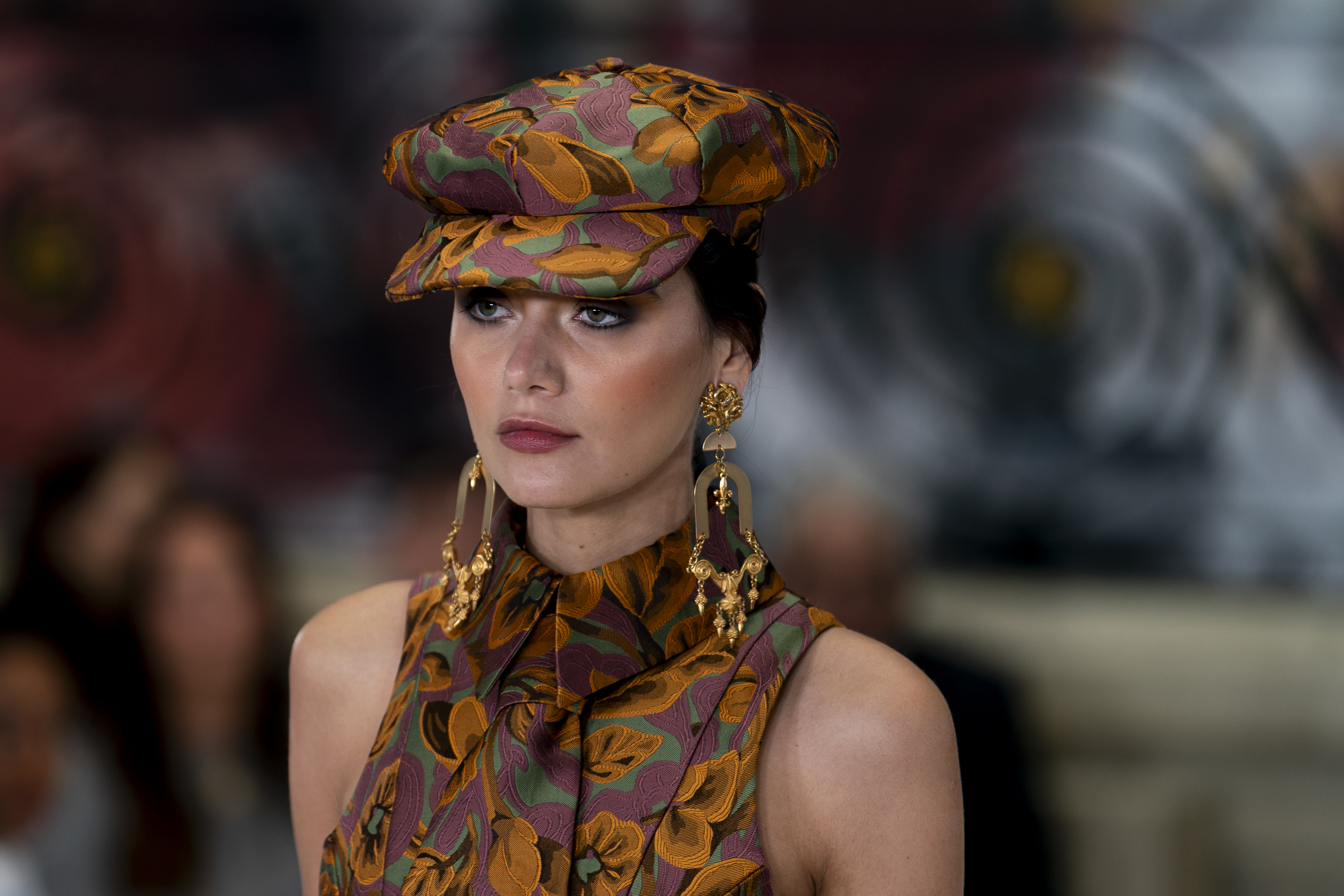 Modal wears maximalist printed dress and hat