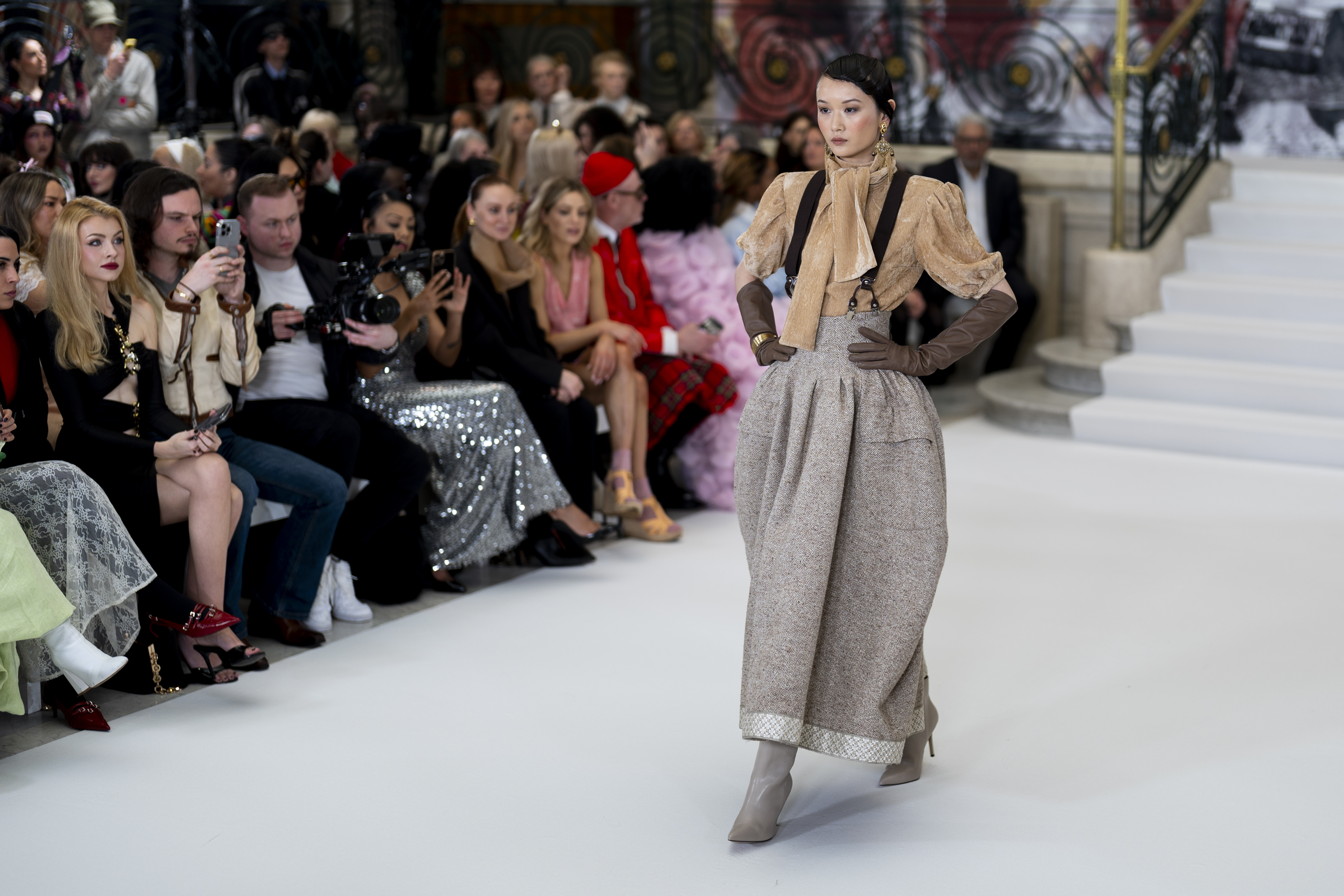 Model wears suspenders on runway