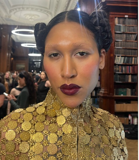 model poses with berry makeup on