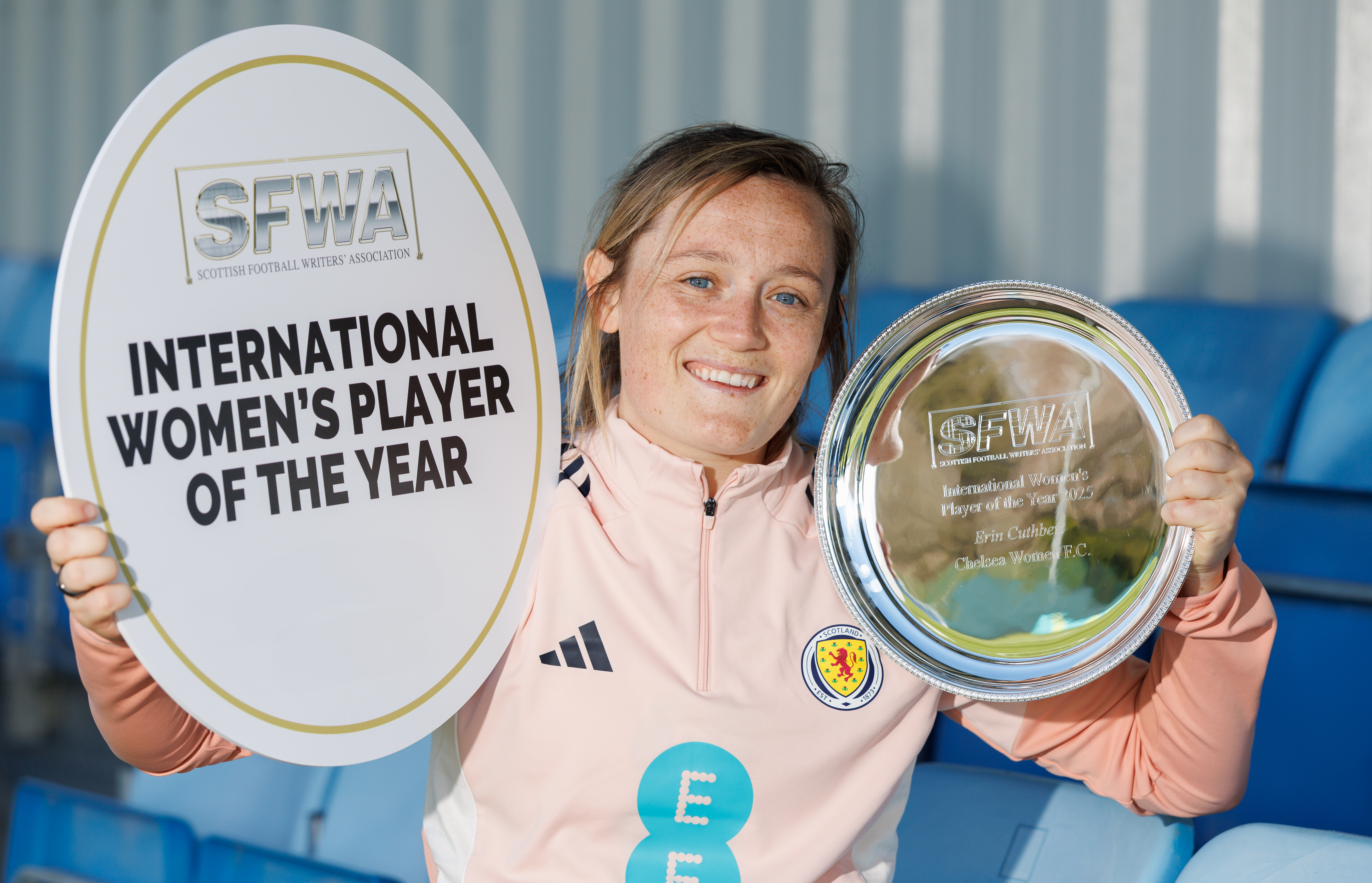Erin Cuthbert holds up her award from the Scottish Football Writers Association