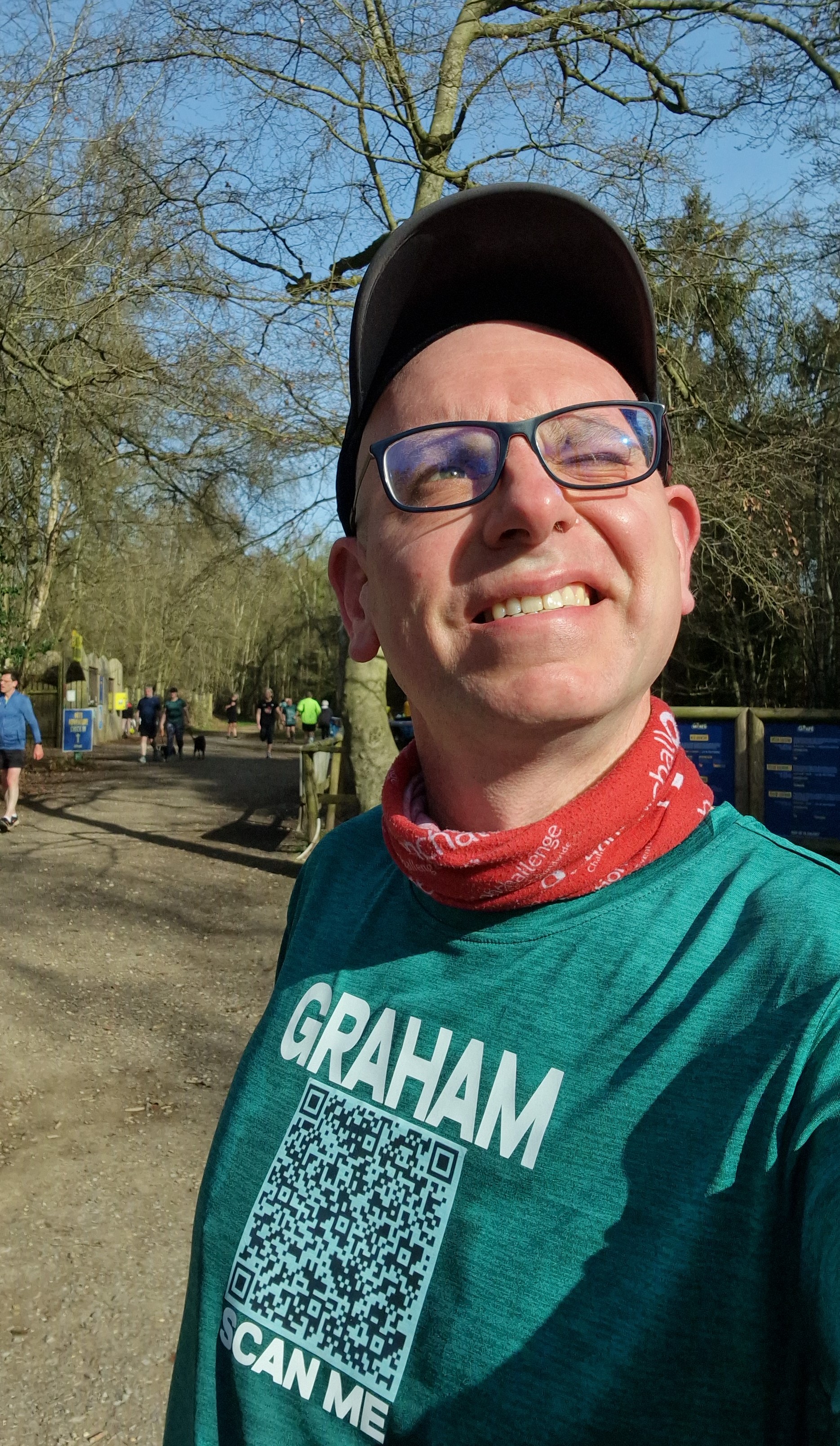 Graham Cooksey wearing a cap, glasses and a T-shirt with his name on
