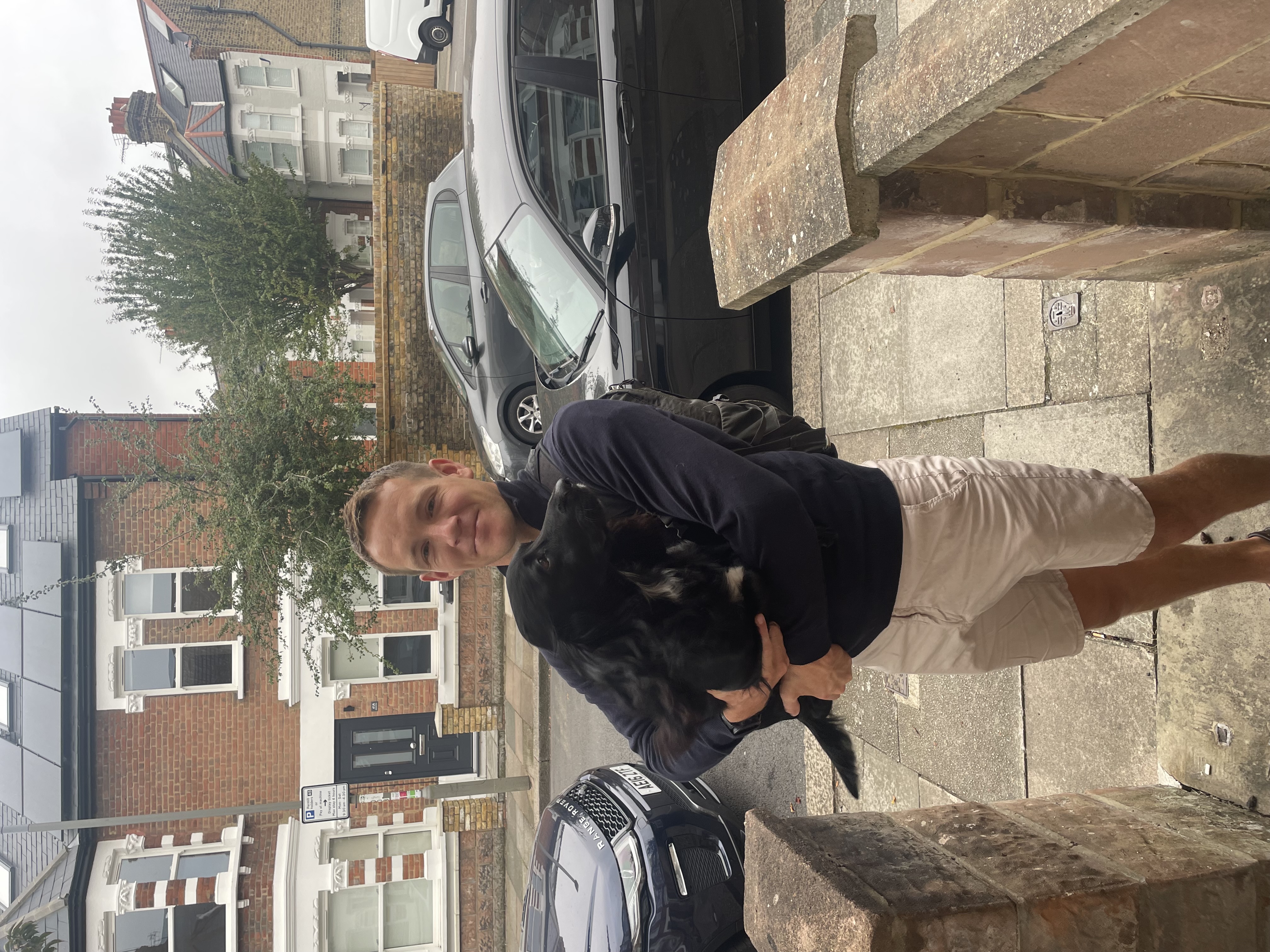 Dylan Wing carrying his dog Herbie