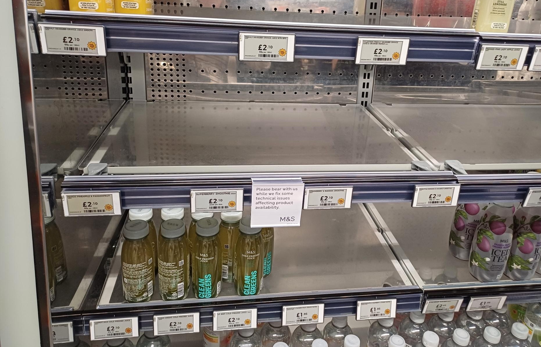 A Marks & Spencer shelf with a notice highlighting availability issues in a store in Paddington, London