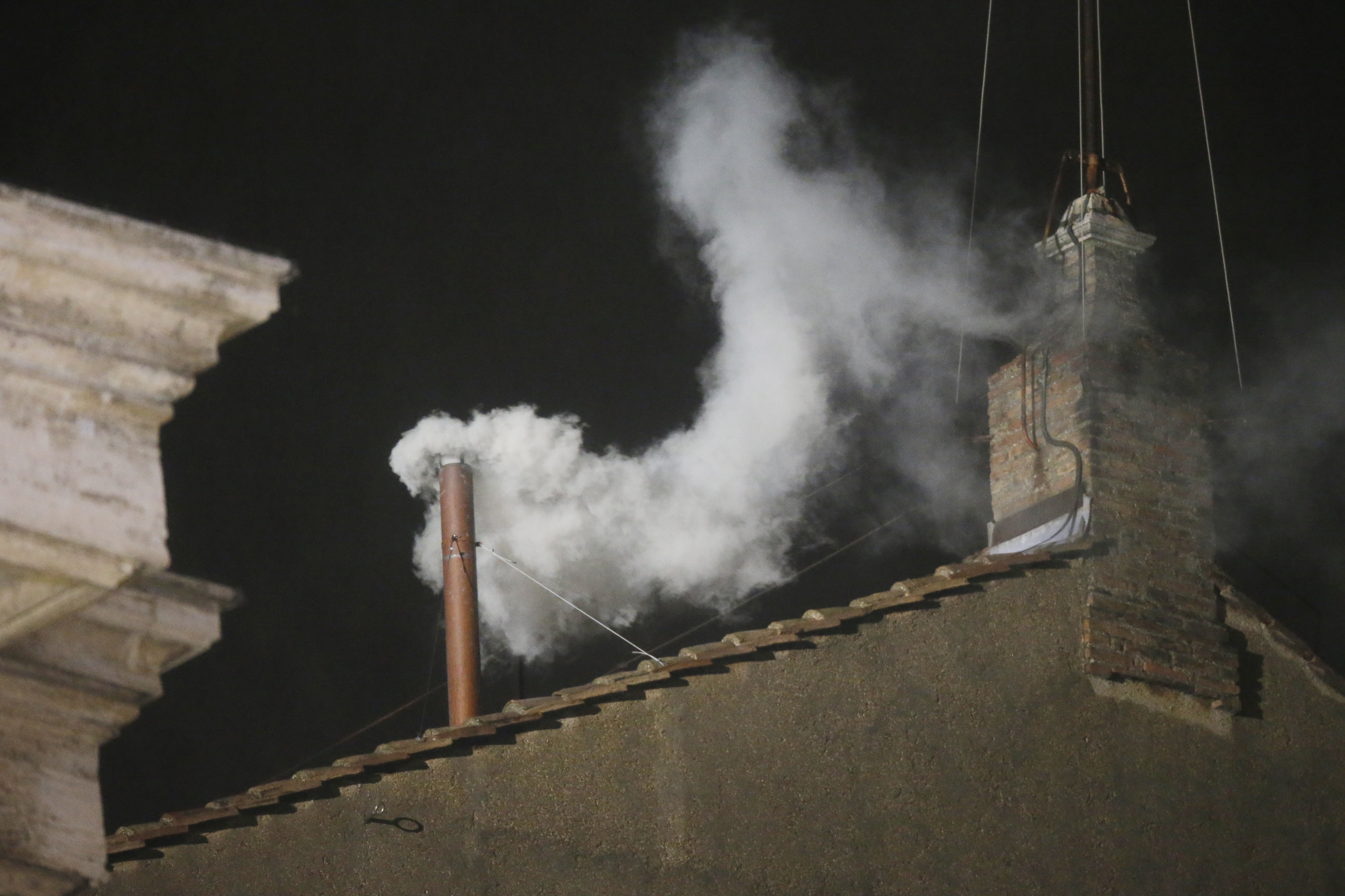 White smoke billows from the chimney of the Sistine Chapel