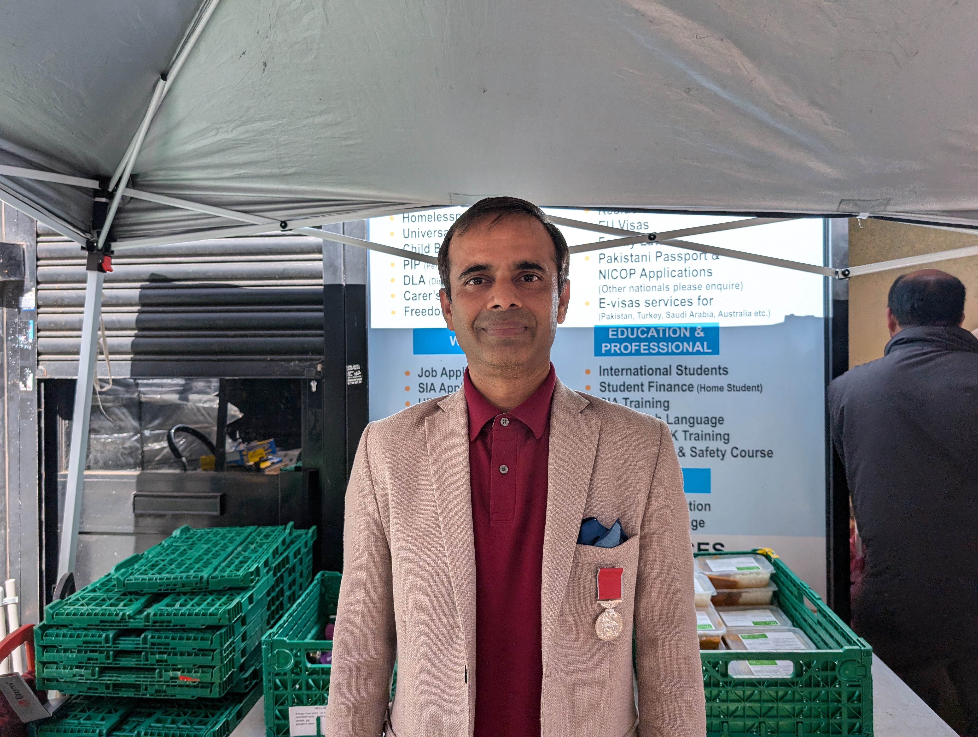 Junaid Ali in front of a stall