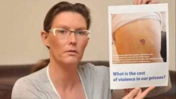 A woman holding a poster